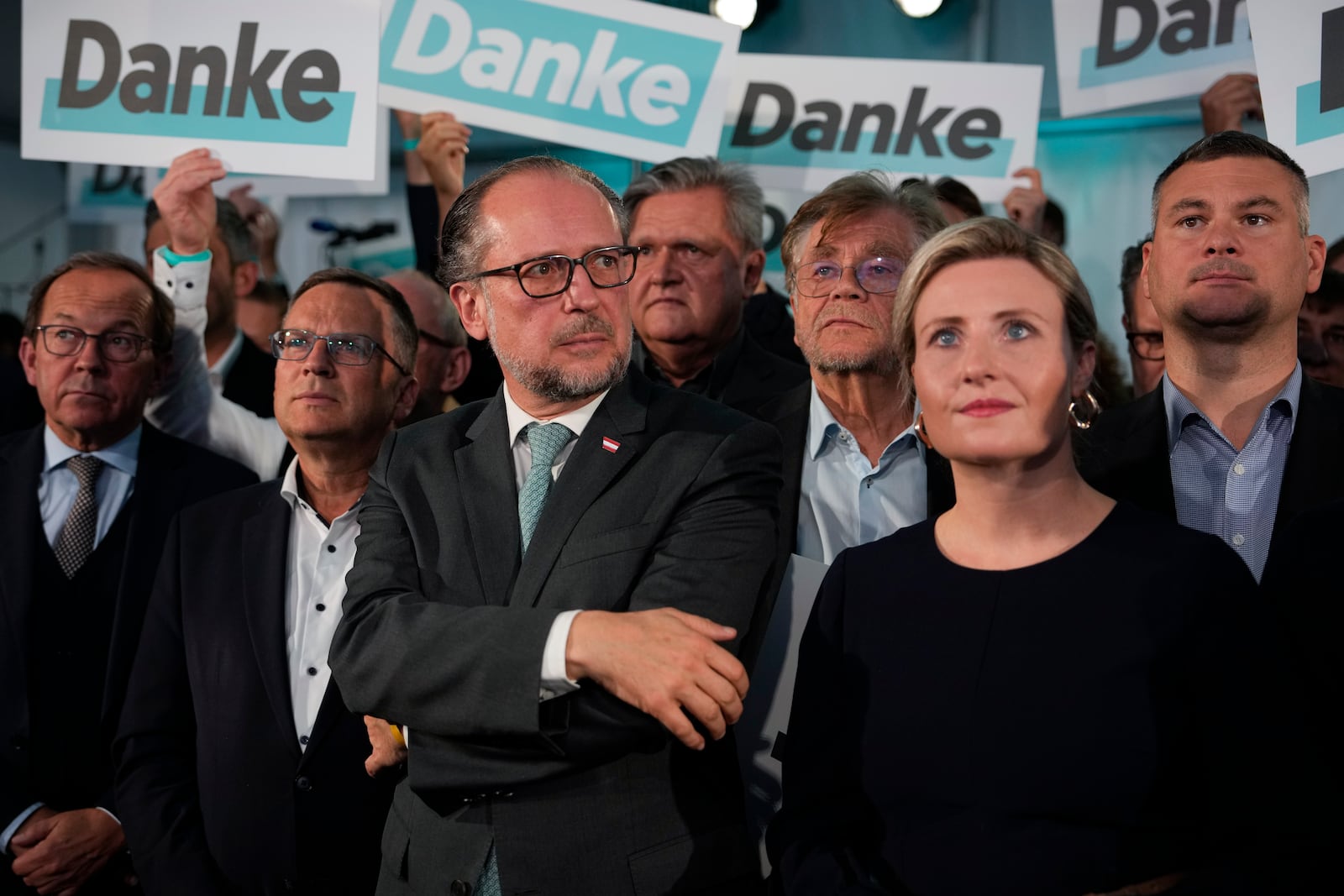 Austria's Foreign Minister Alexander Schallenberg, center left, and Susanne Raab of the at the OVP, Austrian People's Party, look on as supporters hold "Thank You" banners at the party headquarters in Vienna, Austria, Sunday, Sept. 29, 2024, after seeing the first electoral projections in the country's national election. (AP Photo/Andreea Alexandru)