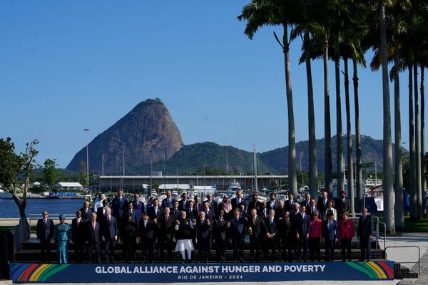 Backdropped by Sugar Loaf mountain, leaders attending the G20 Summit pose for a group photo in Rio de Janeiro, Monday, Nov. 18, 2024. (AP Photo/Eraldo Peres)