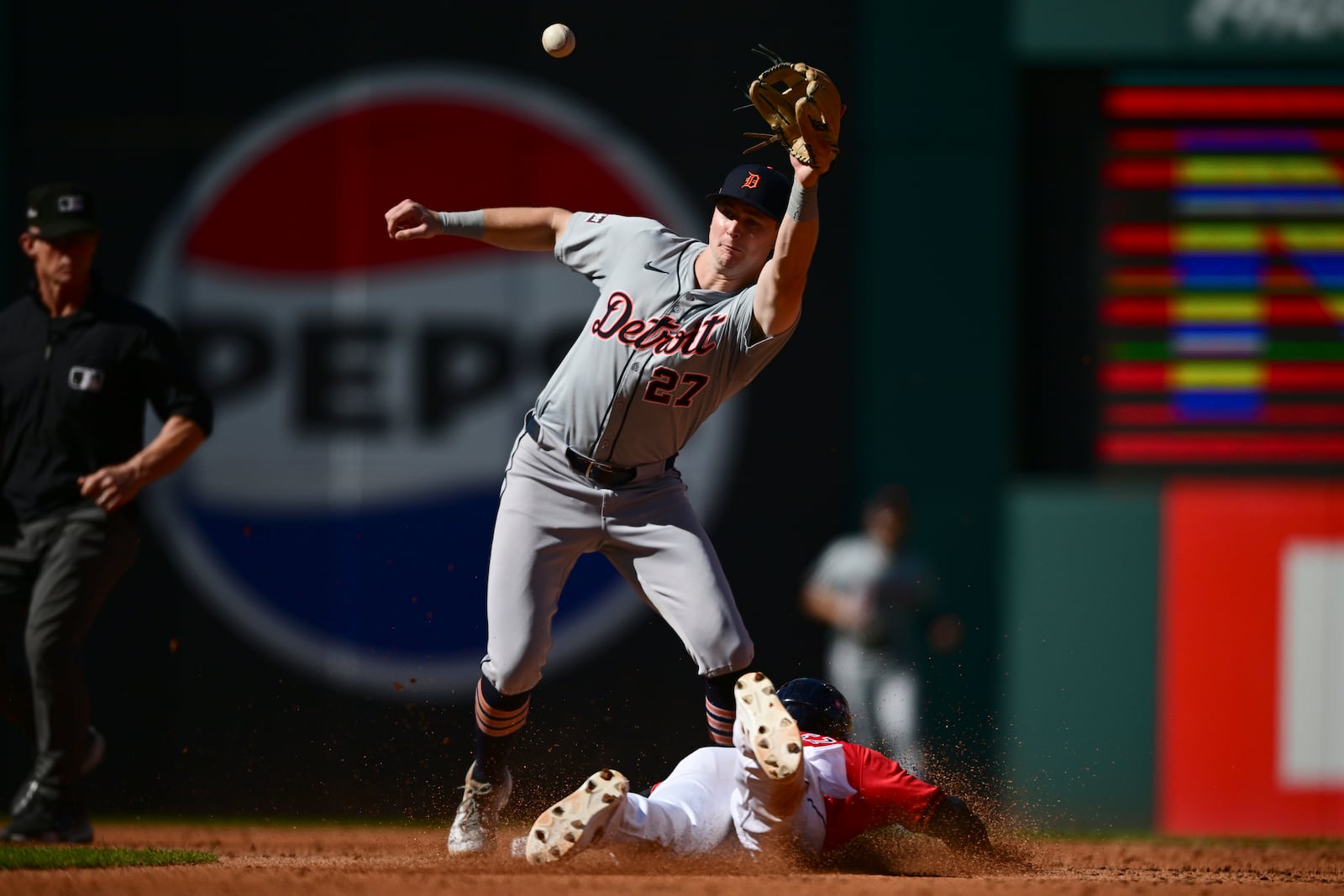 Cleveland Guardians' Andres Gimenez, right, steals second base as Detroit Tigers shortstop Trey Sweeney takes the throw in the third inning during Game 1 of baseball's AL Division Series, Saturday, Oct. 5, 2024, in Cleveland. (AP Photo/David Dermer)