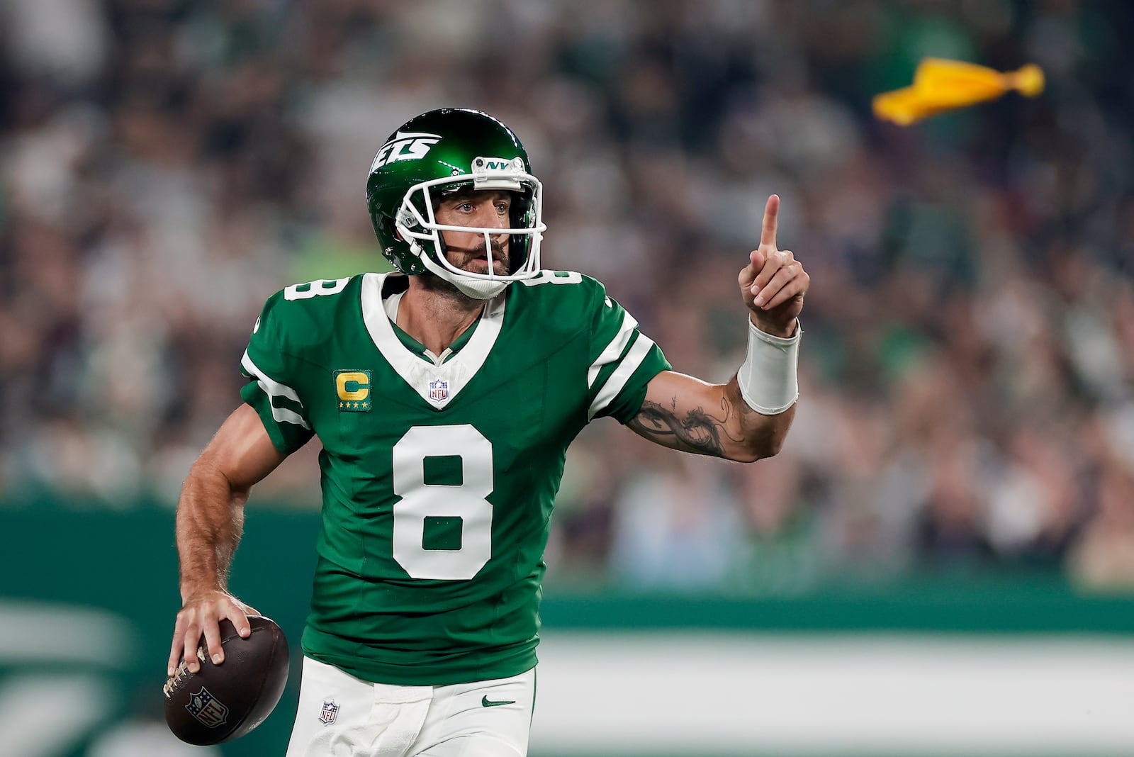 New York Jets quarterback Aaron Rodgers (8) looks to pass against the New England Patriots during the first quarter of an NFL football game, Thursday, Sept. 19, 2024, in East Rutherford, N.J. (AP Photo/Adam Hunger)