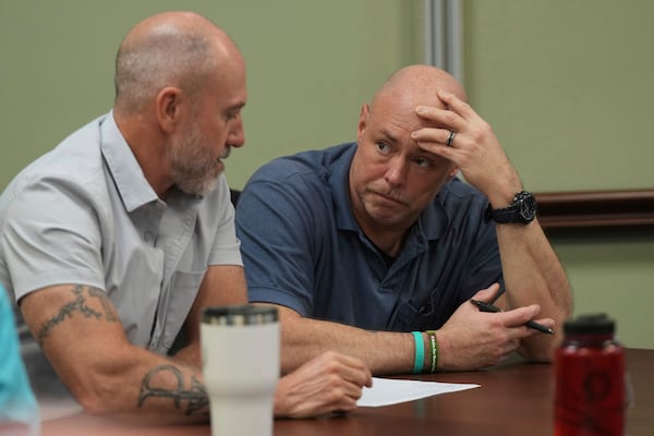 Border Patrol specialist Mitchell Holmes, left, listens to U.S. Fish and Wildlife Regional Law Enforcement agent Kevin Shinn, during a Chaplain Academy training session, Wednesday, Nov. 20, 2024, in Dania Beach, Fla. (AP Photo/Marta Lavandier)