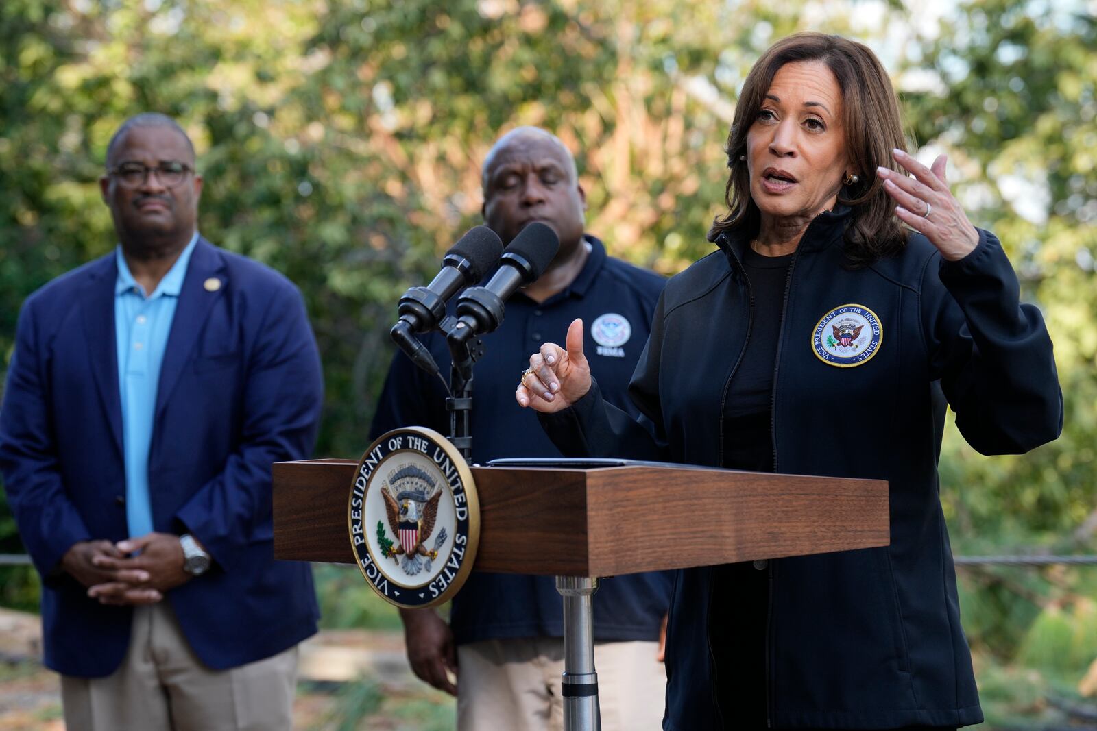 Democratic presidential nominee Vice President Kamala Harris speaks as she tours an area impacted by Hurricane Helene in Augusta, Ga., Wednesday, Oct. 2, 2024, as Augusta Mayor Garnett Johnson, left, and FEMA deputy director Erik Hooks listen. (AP Photo/Carolyn Kaster)