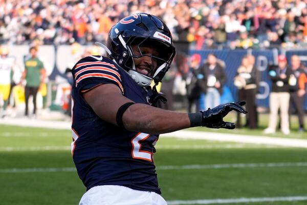 Chicago Bears' Roschon Johnson celebrates his touchdown run during the first half of an NFL football game against the Green Bay Packers Sunday, Nov. 17, 2024, in Chicago. (AP Photo/Charles Rex Arbogast)