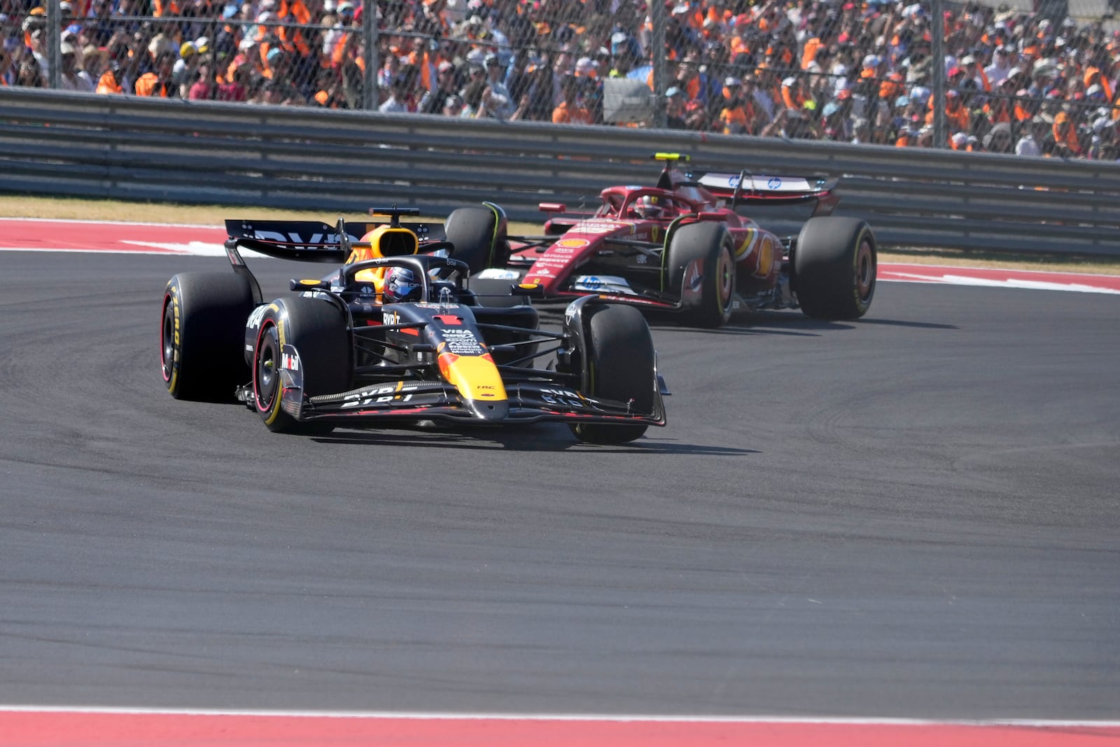 Red Bull driver Max Verstappen, of the Netherlands, leads Ferrari driver Carlos Sainz, of Spain, through a turn during U.S. Grand Prix auto race at Circuit of the Americas, Sunday, Oct. 20, 2024, in Austin, Texas. (AP Photo/Eric Gay)