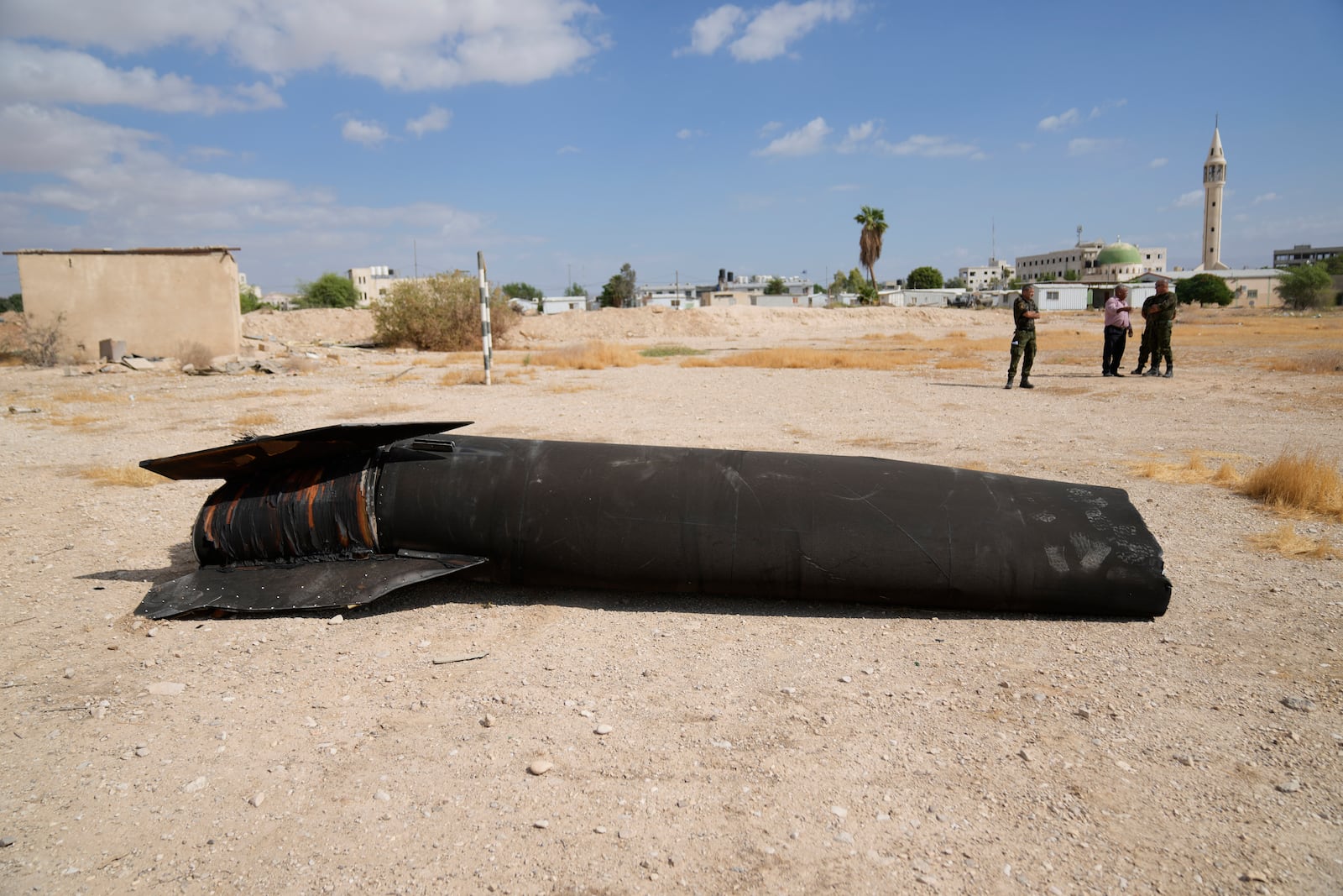 Officers of the Palestinian National forces inspect part of a rocket, launched during Iran's strike against Israel, at a facility of their unit in the West Bank city of Jericho, Wednesday, Oct. 2, 2024. (AP Photo/Nasser Nasser)