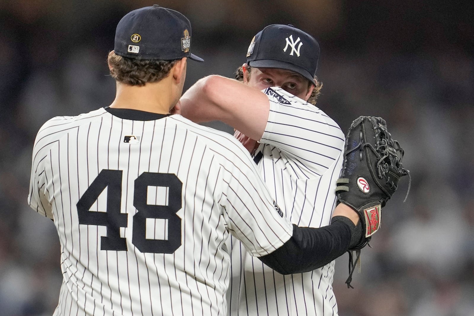 New York Yankees first baseman Anthony Rizzo (48) talks with starting pitcher Gerrit Cole during the fifth inning in Game 5 of the baseball World Series against the Los Angeles Dodgers, Wednesday, Oct. 30, 2024, in New York. (AP Photo/Godofredo A. Vásquez)