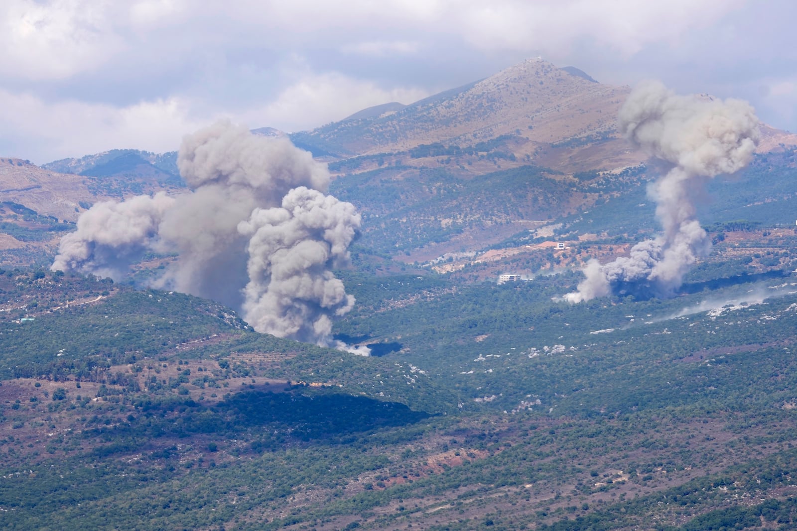 Smoke rises from Israeli airstrikes that hit Al-Rihan mountain, as seen from Marjayoun town, south Lebanon, Saturday, Sept. 21, 2024. (AP Photo/Hussein Malla)