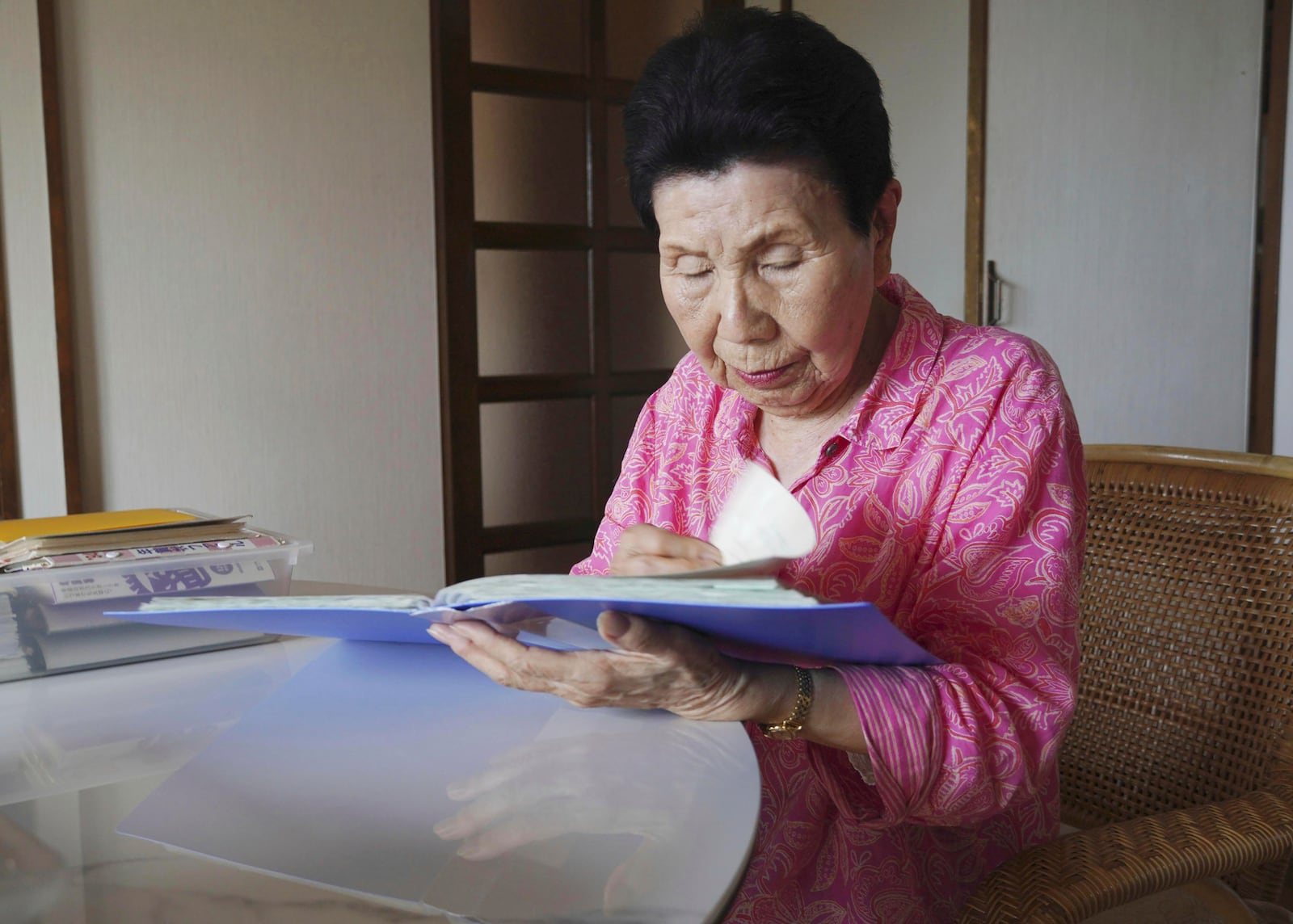 Hideko Hakamada, sister of former boxer Iwao Hakamada who has been on death row for the 1966 murder case, rereads letters that her brother wrote from prison, in Hamamatsu, Shizuoka prefecture, central Japan, in May 2024. Japanese prosecutors said on Oct. 8, 2024 they will not appeal the Sept. 26 ruling of the Shizuoka District Court that acquitted the world’s longest-serving death-row inmate in a retrial. (Kyodo News via AP)