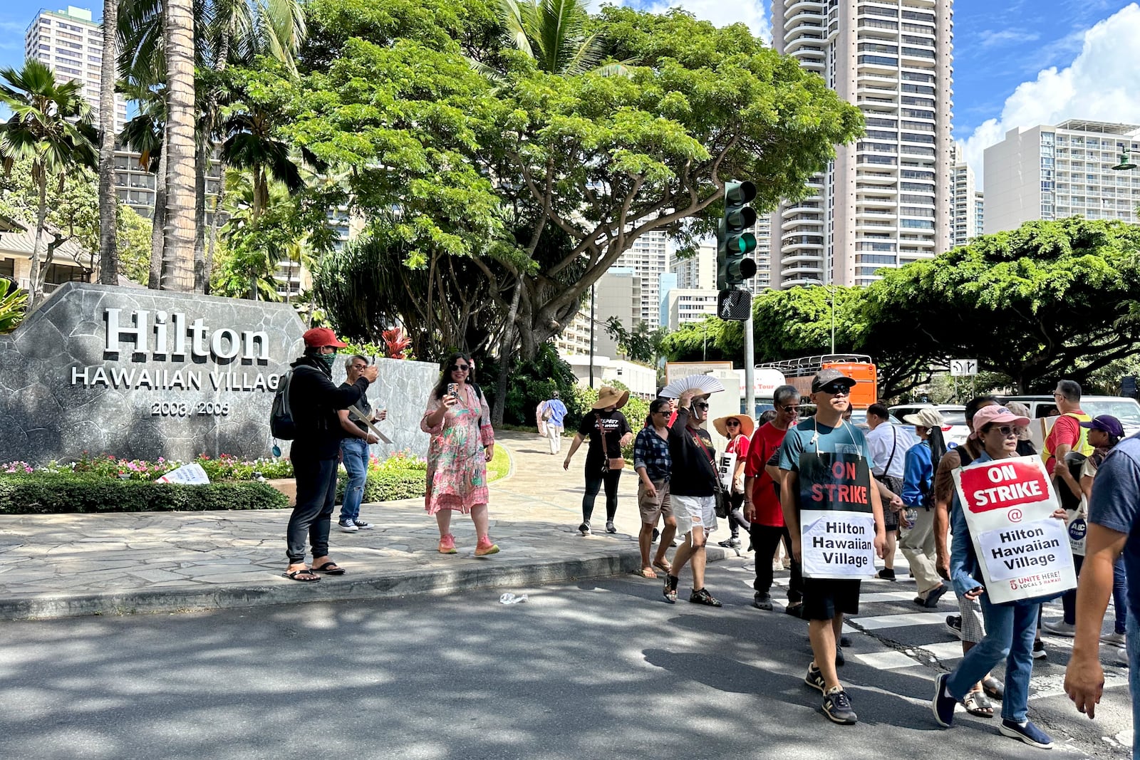 Hotel workers march outside the Hilton Hawaiian Village resort after going on strike on Tuesday, Sept. 24, 2024, in Honolulu. (AP Photo/Jennifer Sinco Kelleher)