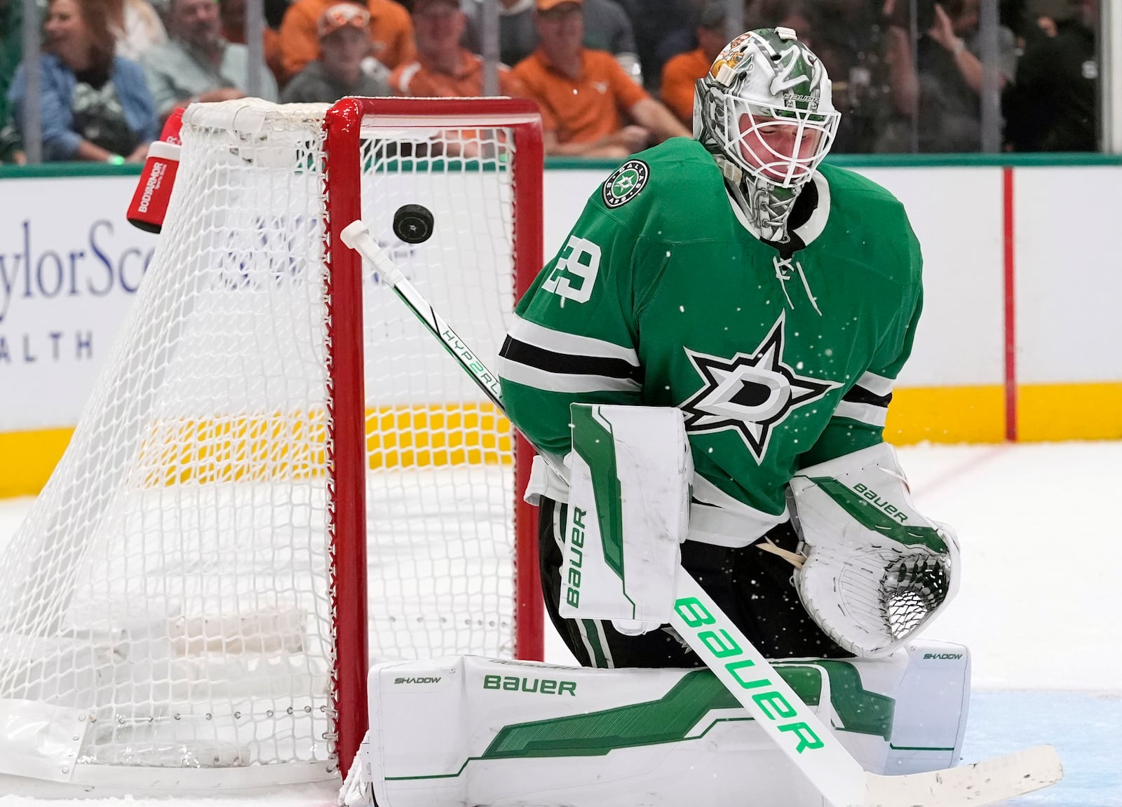 Dallas Stars goaltender Jake Oettinger (29) deflects a shot on goal during the second period of an NHL hockey game against the New York Islanders, Saturday, Oct. 12, 2024, in Dallas. (AP Photo/LM Otero)