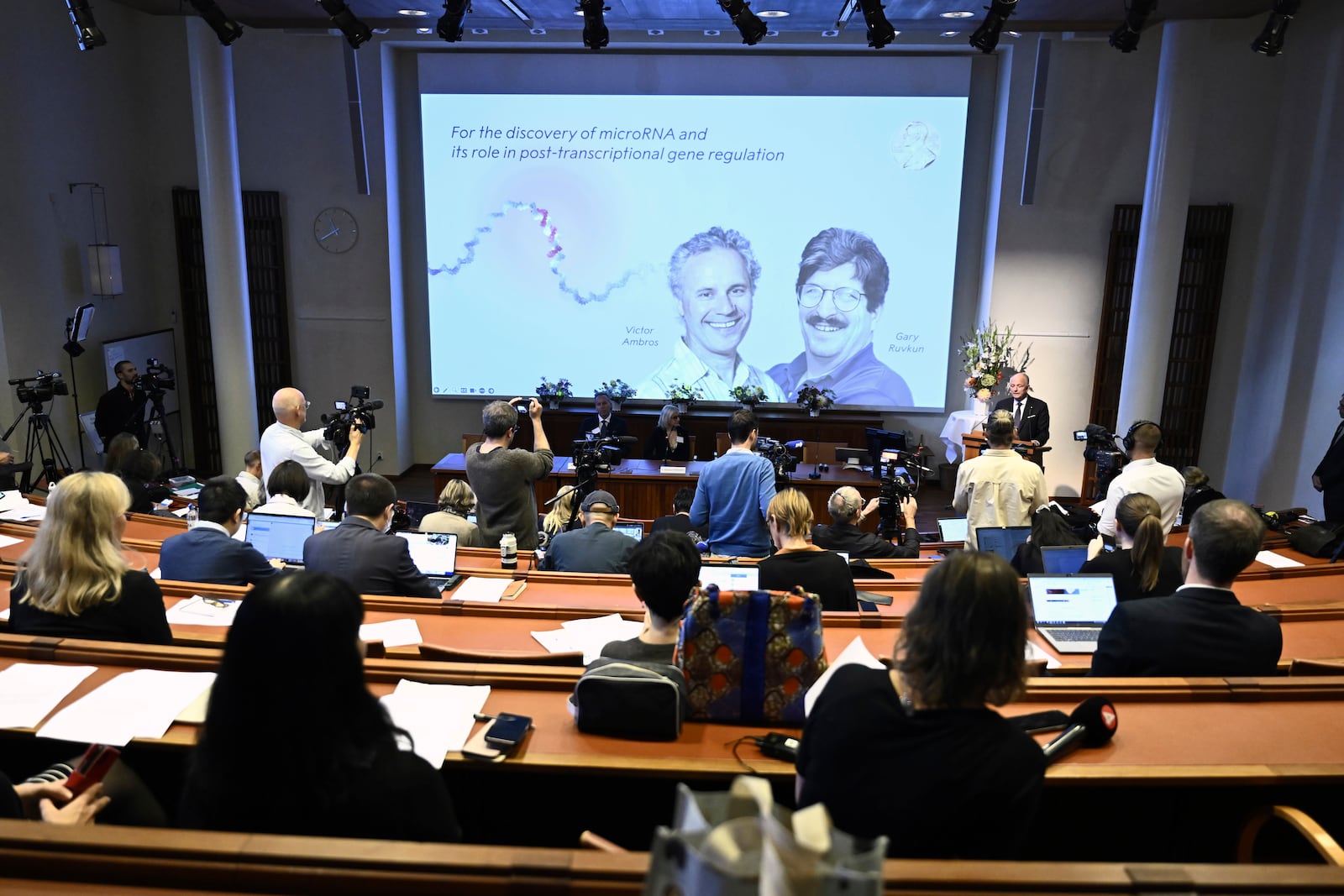 Americans Victor Ambros, left, and Gary Ruvkun, are seen on a screen after being awarded this year's Nobel Prize in Physiology or Medicine during a press conference to announce the winners at the Karolinska Institute in Stockholm, Sweden, on Monday, Oct. 7, 2024. (Christine Olsson/TT News Agency via AP)