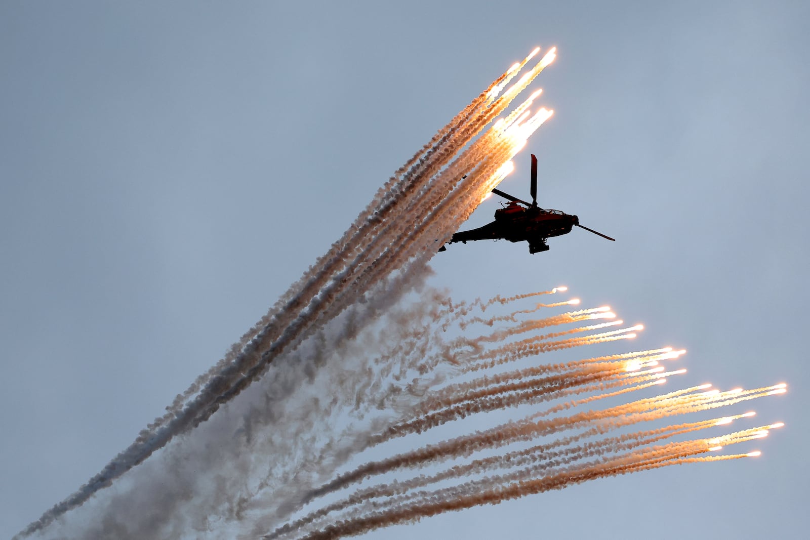 A South Korean army Apache helicopter fires flares during a celebration to mark 76th anniversary of Korea Armed Forces Day, in Seongnam, South Korea, Tuesday, Oct.1, 2024. (Kim Hong-Ji/Pool Photo via AP)