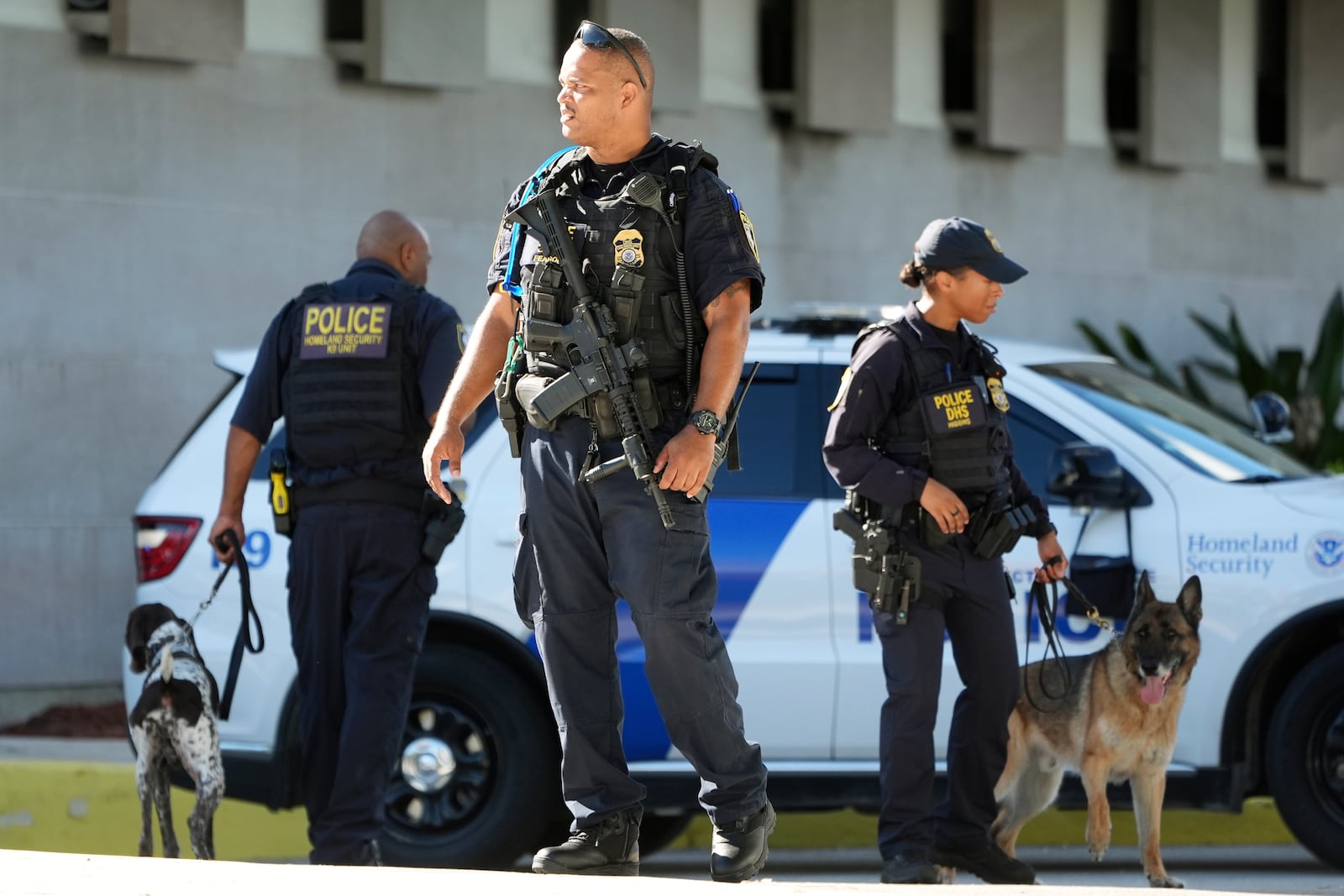 Department of Homeland Security officers patrol outside the Paul G. Rogers Federal Building and U.S. Courthouse, where Ryan Wesley Routh, 58, suspected in an apparent assassination attempt targeting former President Donald Trump, will be attending a hearing, Monday, Sept. 23, 2024, in West Palm Beach, Fla. (AP Photo/Wilfredo Lee)