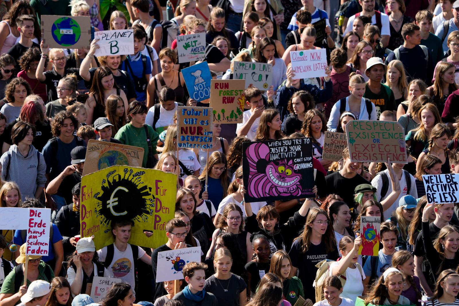 Students hold placards as they take part in a Global Climate Strike protest, part of the Fridays For Future movement, near the chancellery in Berlin, Germany, Friday, Sept. 20, 2024. (AP Photo/Markus Schreiber)