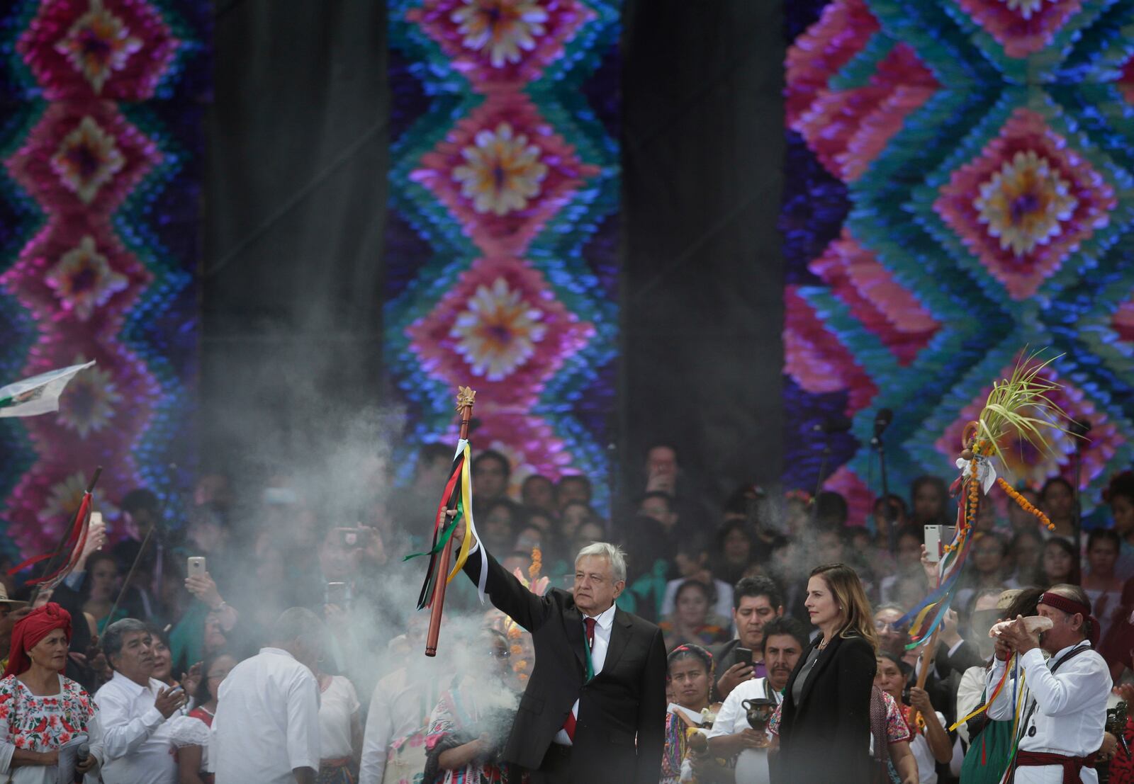 FILE - Newly elected President Andres Manuel Lopez Obrador holds a chieftain's staff during an Indigenous ceremony at the Zocalo in Mexico City, Dec. 1, 2018. (AP Photo/Eduardo Verdugo, File)