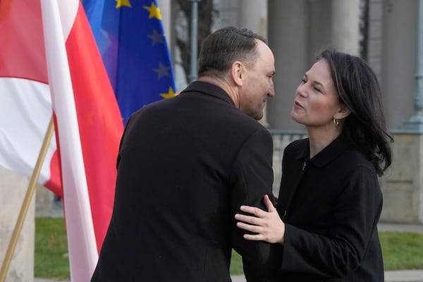 Germany's Foreign Minister Annalena Baerbock, right, is greeted by Poland's Foreign Minister Radoslaw Sikorski, upon her arrival for a meeting of European foreign ministers, in Warsaw, Tuesday, Nov. 19, 2024. (AP Photo/Czarek Sokolowski)