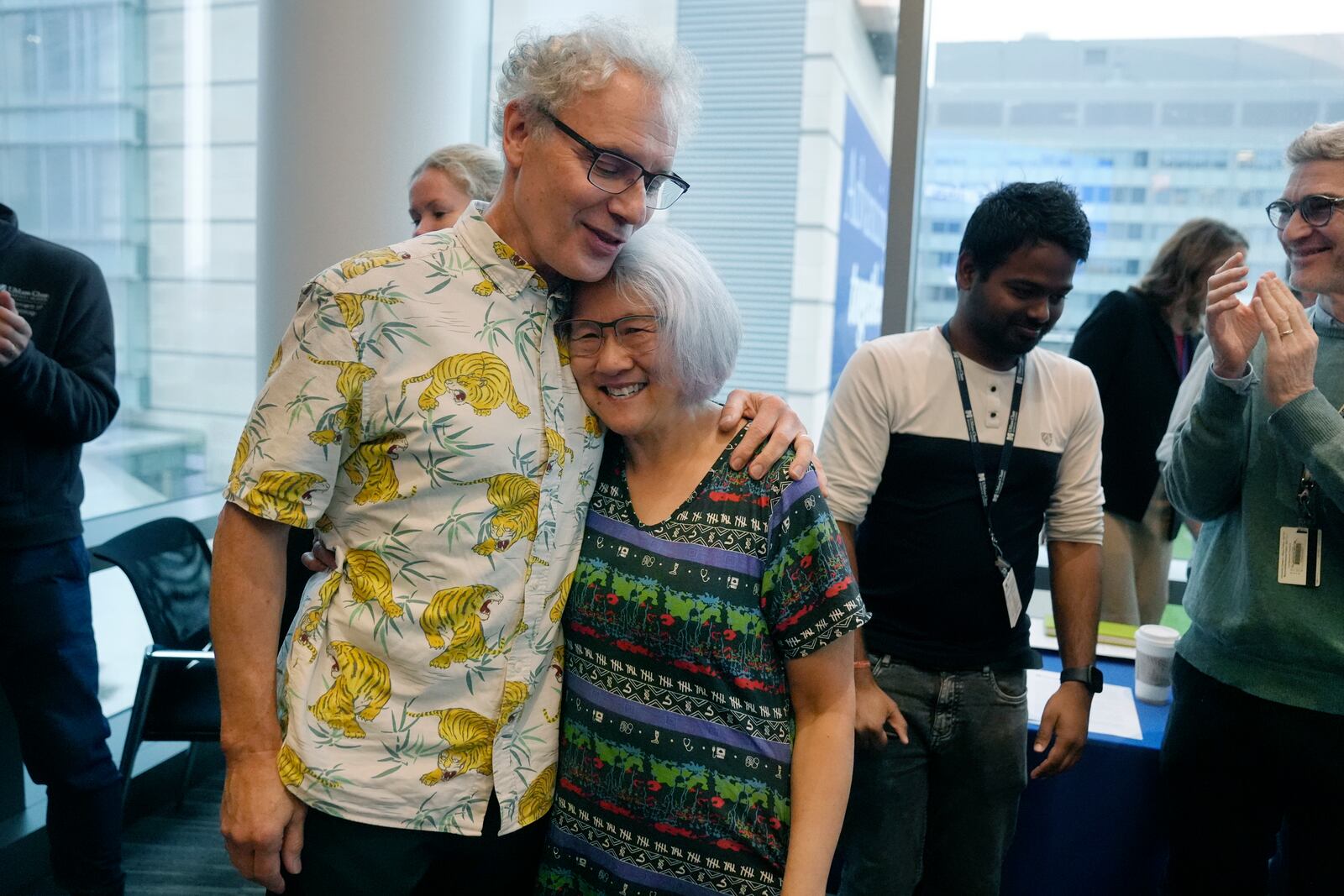 Victor Ambros, left, 2024 Nobel Prize winner in physiology or medicine, and professor of natural science at the University of Massachusetts Medical School, hugs his wife Rosalind Lee following a news conference, Monday, Oct. 7, 2024, at the school in Worcester, Mass. (AP Photo/Steven Senne)