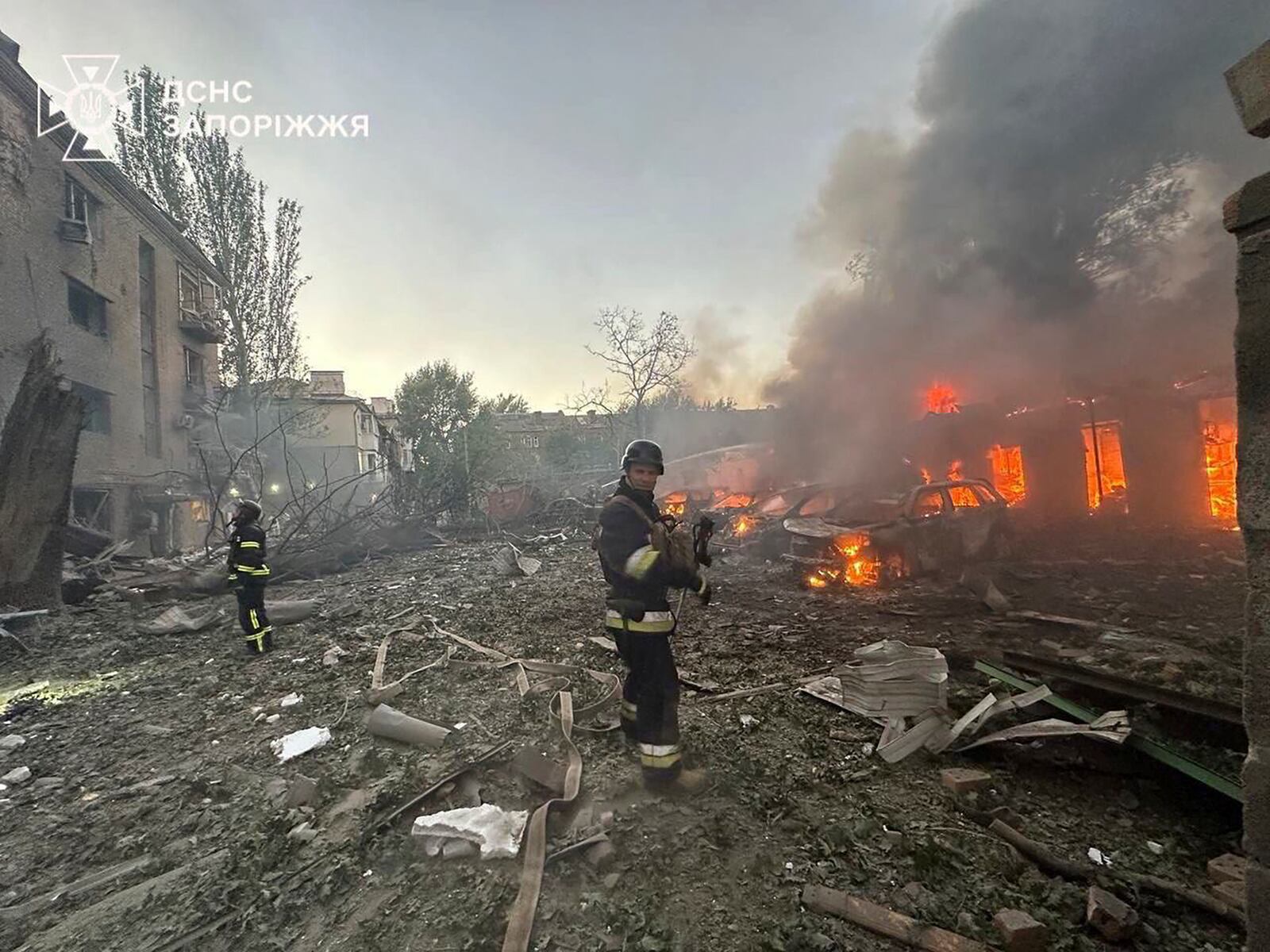 In this photo provided by the Ukrainian Emergency Service, firefighters put out the fire after Russia attacked the city with guided bombs overnight in Zaporizhzhia, Ukraine, Sunday, Sept. 29, 2024. (Ukrainian Emergency Service via AP)