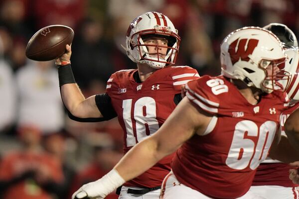 Wisconsin's Braedyn Locke (18) thorws a pass during the first half of an NCAA college football game against Oregon Saturday, Nov. 16, 2024, in Madison, Wis. (AP Photo/Morry Gash)