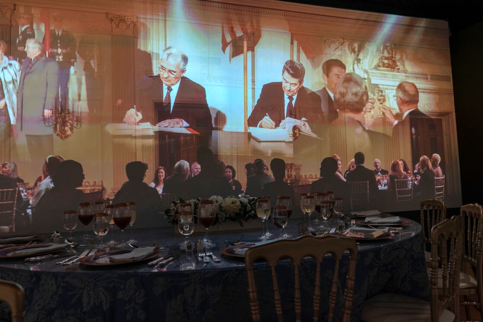 A 3D interactive room with dinner tables, music and videos of State Dinners at the White House shown at The People's House exhibit, Monday, Sept. 16, 2024 in Washington. (AP Photo/Jose Luis Magana)