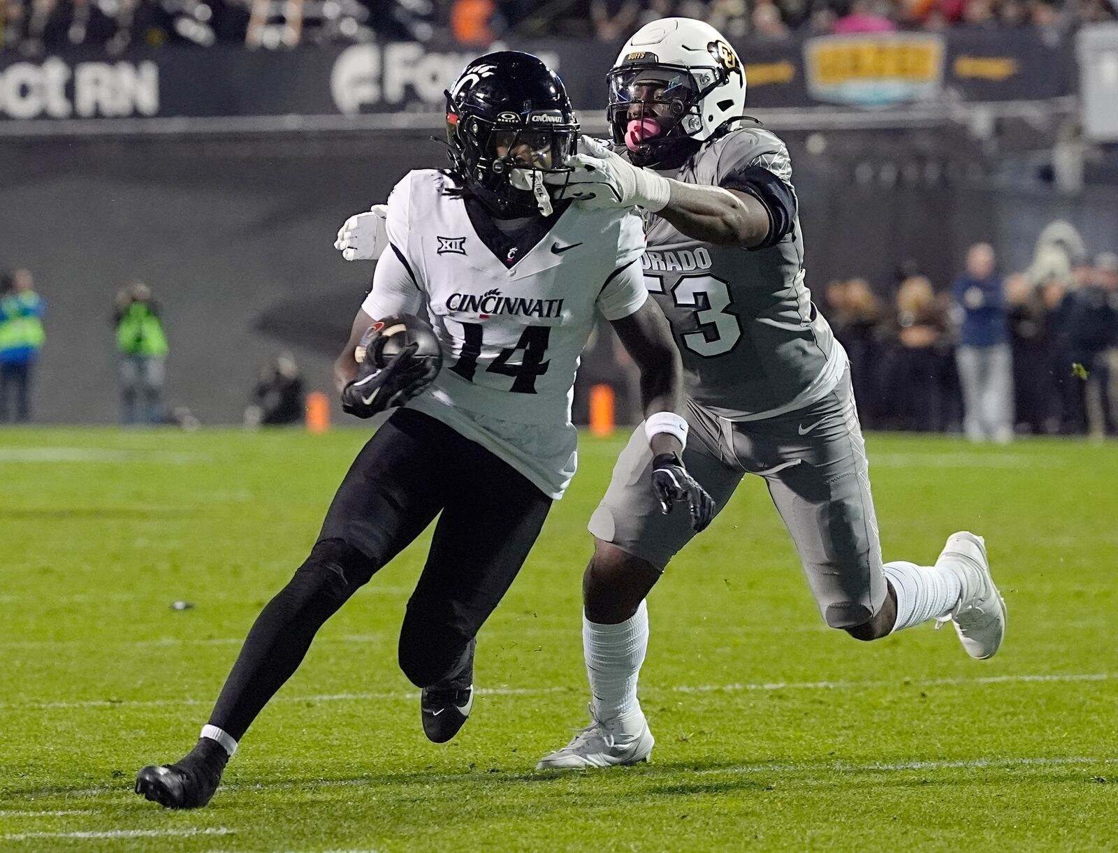 Cincinnati wide receiver Barry Jackson Jr., left, is stopped after a short gain by Colorado defensive end Arden Walker in the first half of an NCAA college football game Saturday, Oct. 26, 2024, in Boulder, Colo. (AP Photo/David Zalubowski)