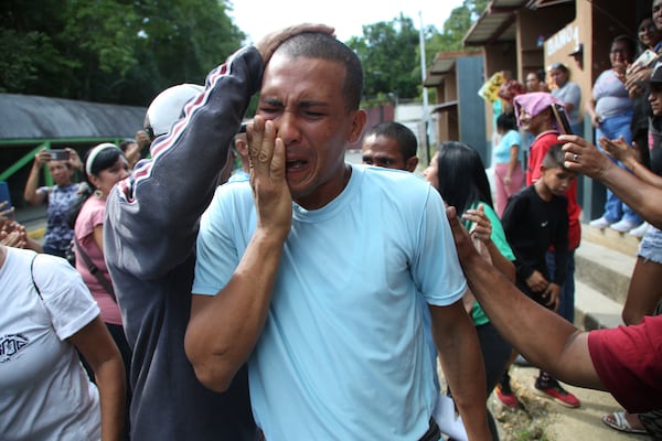 A person who was detained during a government crackdown following anti-government protests against the results of the presidential election, is overcome by emotion upon his release from the Yare 3 prison, in San Francisco de Yare, Venezuela, Saturday, Nov. 16, 2024. (AP Photo/Cristian Hernandez)