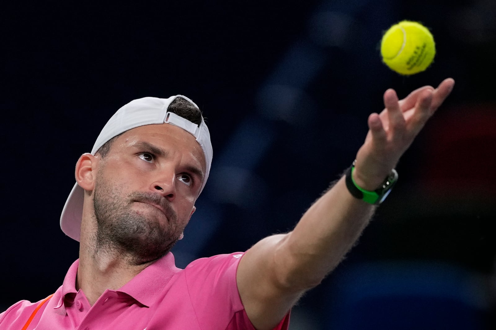 Grigor Dimitrov of Bulgaria tosses the ball to serve against Zizou Bergs of Belgium during the men's singles second round match in the Shanghai Masters tennis tournament at Qizhong Forest Sports City Tennis Center in Shanghai, China, Monday, Oct. 7, 2024. (AP Photo/Andy Wong)