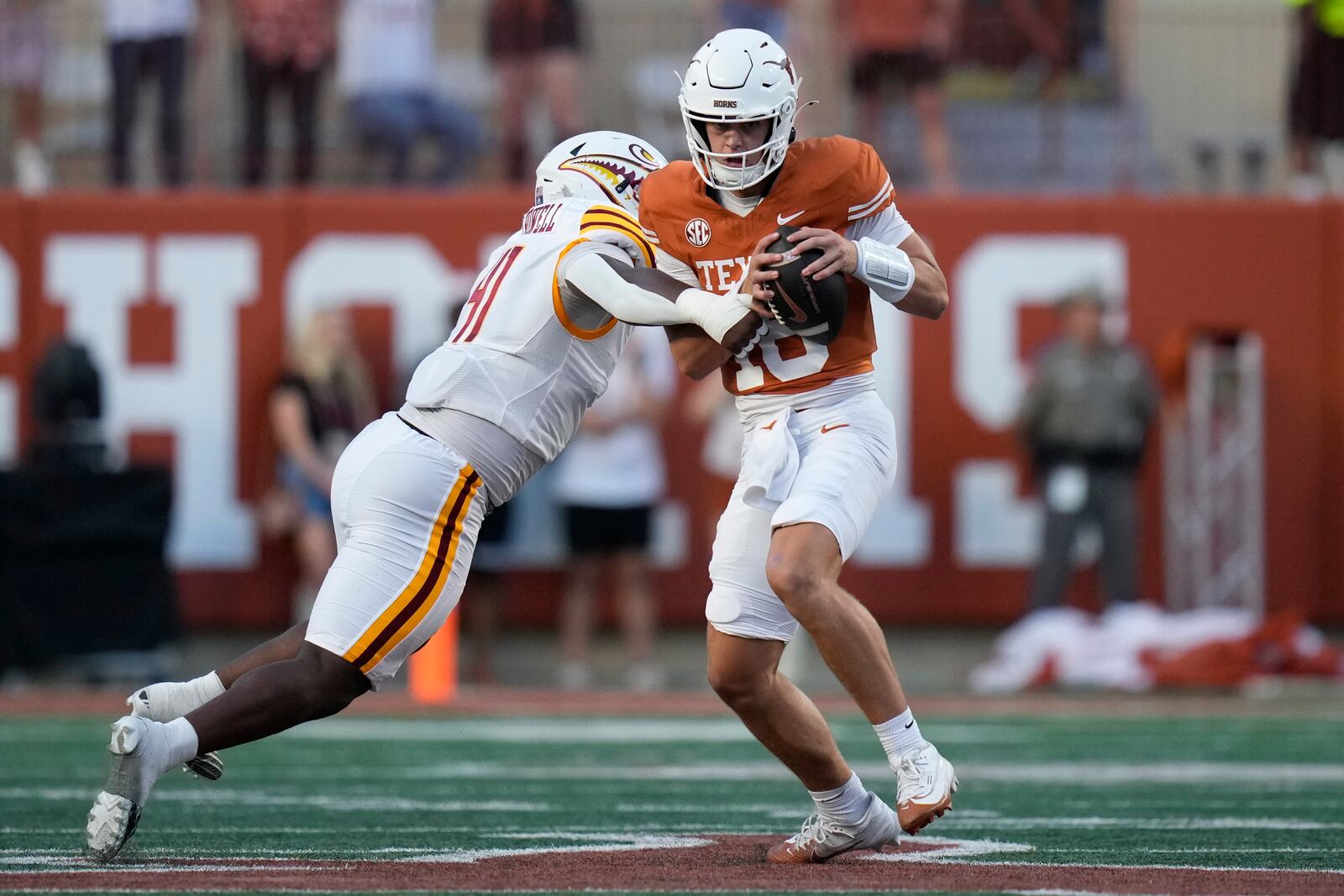 Texas quarterback Arch Manning (16) is pressured by Louisiana-Monroe defensive lineman Dylan Howell (41) during the first half of an NCAA college football game in Austin, Texas, Saturday, Sept. 21, 2024. (AP Photo/Eric Gay)