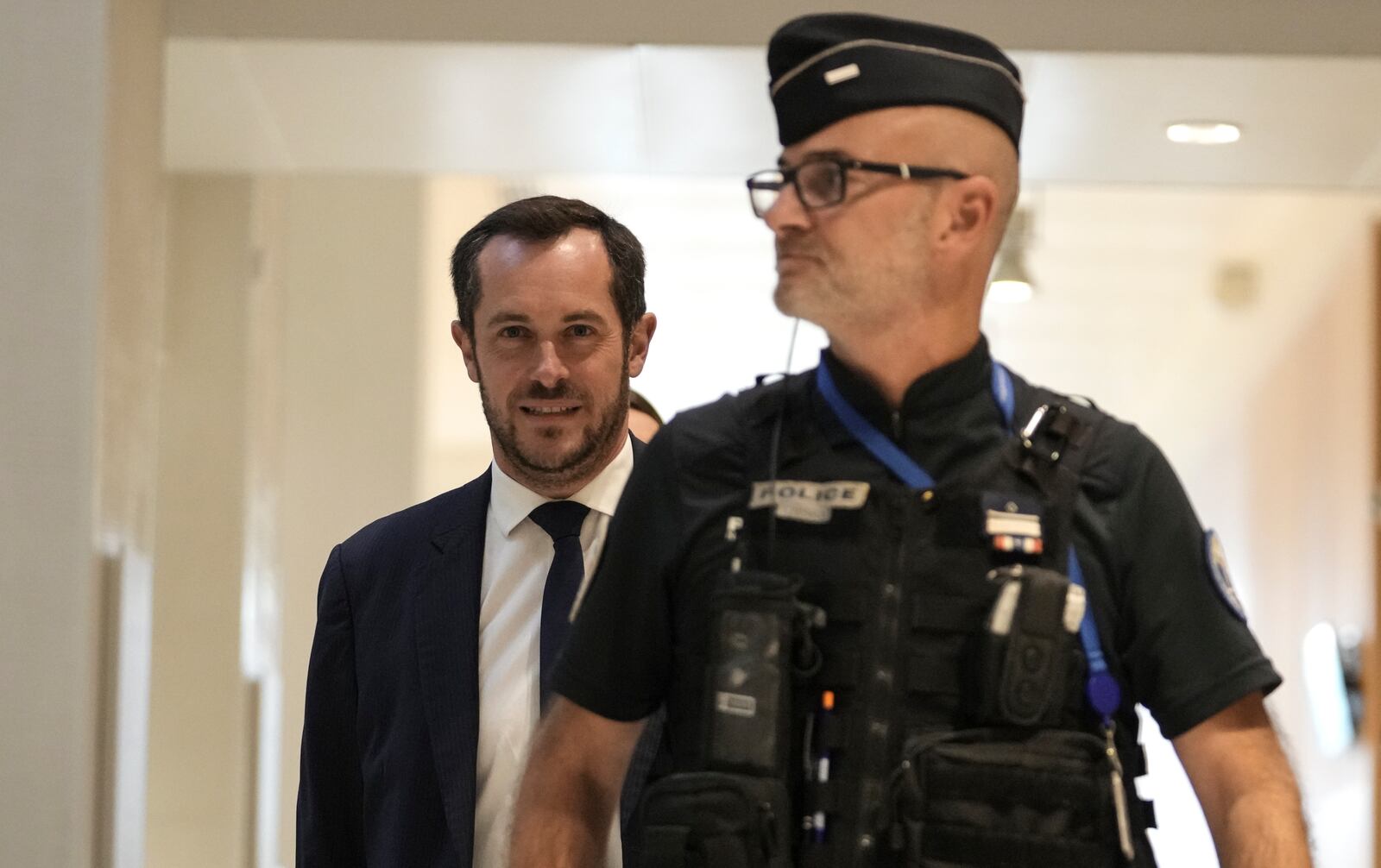 The member of the French far right party Nicolas Bay, rear, arrives at the court house in Paris, Monday, Sept. 30, 2024. (AP Photo/Thibault Camus)