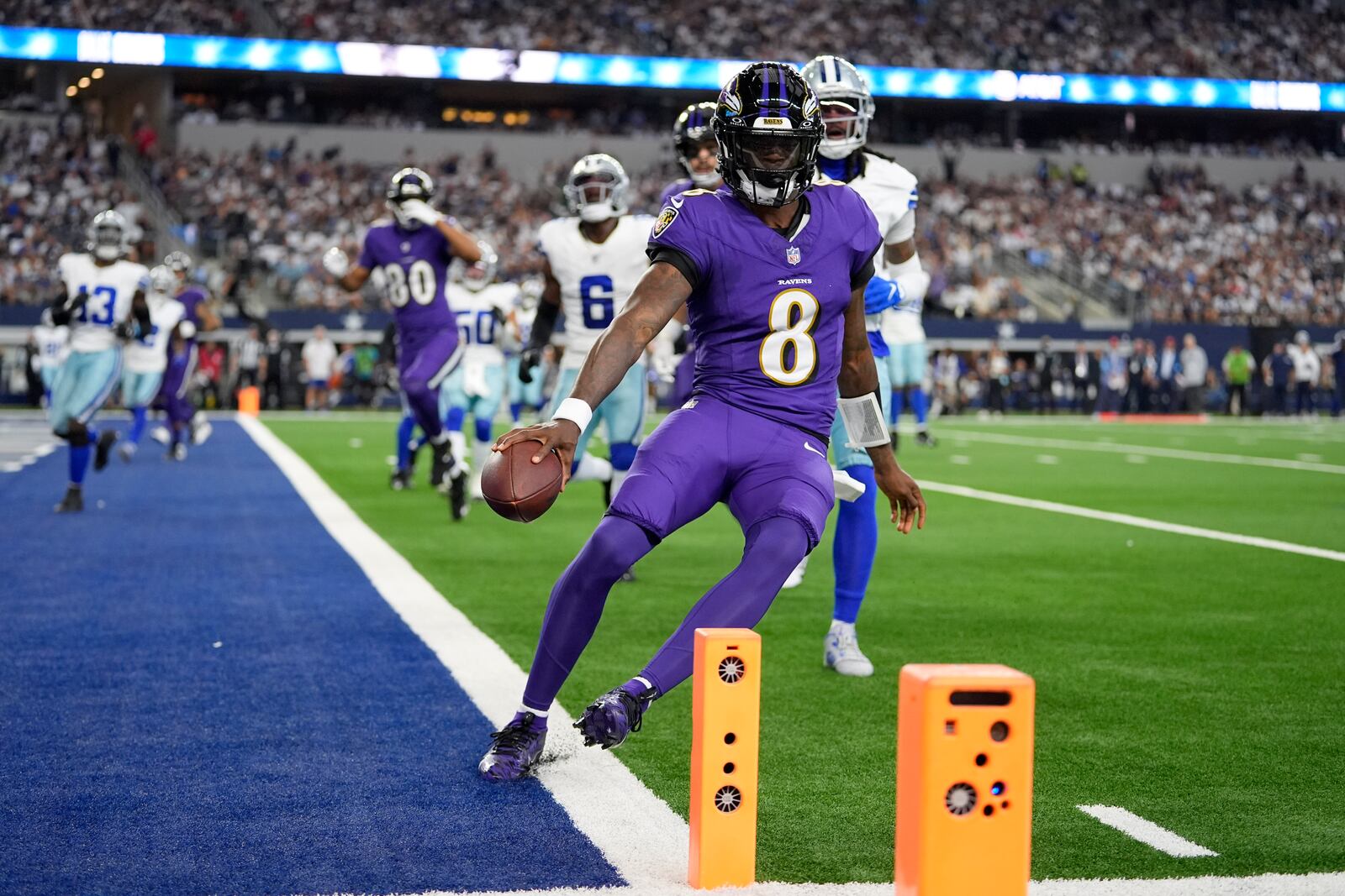 Baltimore Ravens quarterback Lamar Jackson (8) runs the ball for a touchdown against the Dallas Cowboys in the first half of an NFL football game in Arlington, Texas, Sunday, Sept. 22, 2024. (AP Photo/Julio Cortez)