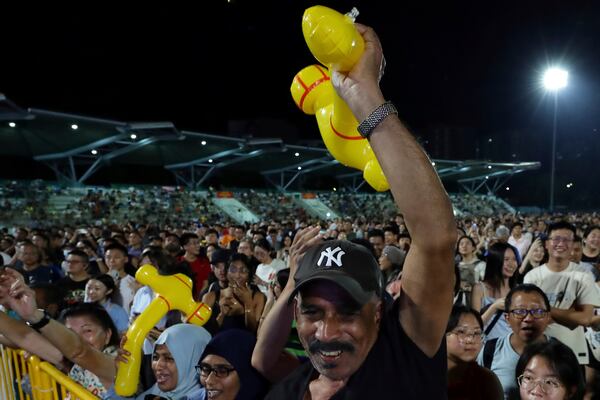 Workers' Party (WP) supporters react at an assembly centre during the general election, in Singapore, Saturday, May 3, 2025. (AP Photo/Suhaimi Abdullah)