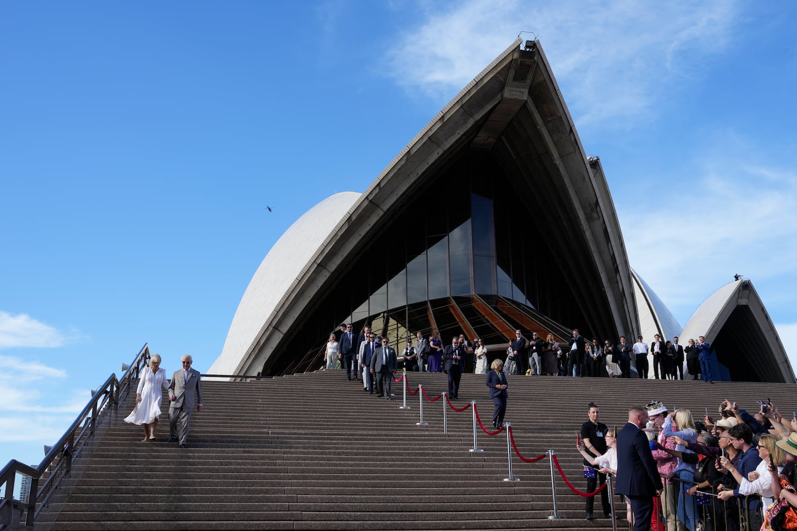 Britain's King Charles III and Queen Camilla goes down the stairs of the Sydney Opera House during their visit in Sydney, Australia, Tuesday, Oct. 22, 2024. (AP Photo/Mark Baker, Pool)