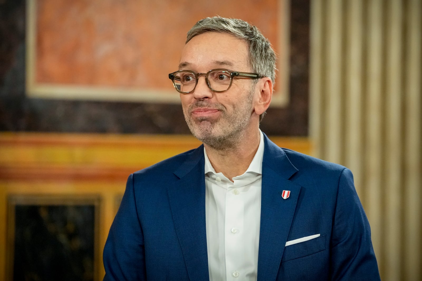 Herbert Kickl, leader of the Freedom Party of Austria smiles while standing at the national broadcaster studio, set up in the parliament building, in Vienna, Austria, Sunday, Sept. 29, 2024, after polls closed in the country's national election. (AP Photo/Andreea Alexandru)