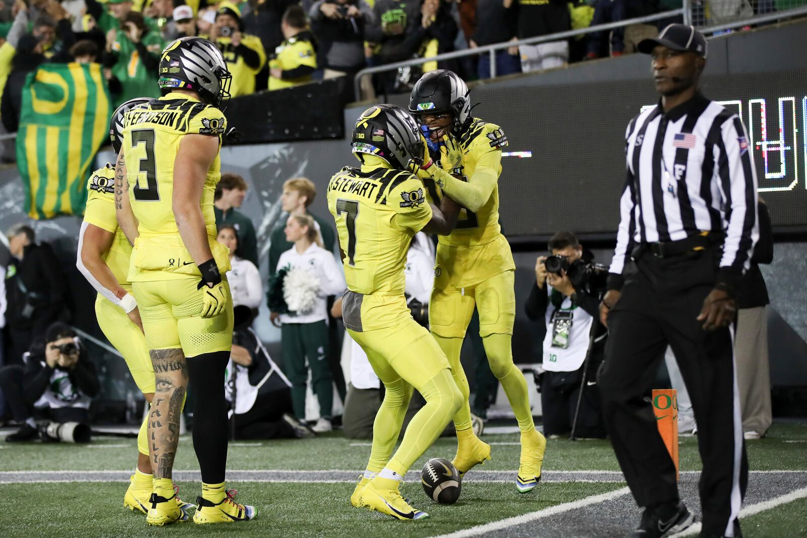 Oregon Ducks wide receiver Tez Johnson, right, celebrates after scoring a touchdown with teammates Dillon Gabriel, Terrance Ferguson, and Evan Stewart during the second half of an NCAA college football game, Friday, Oct. 4, 2024, in Eugene, Ore. (AP Photo/Amanda Loman)