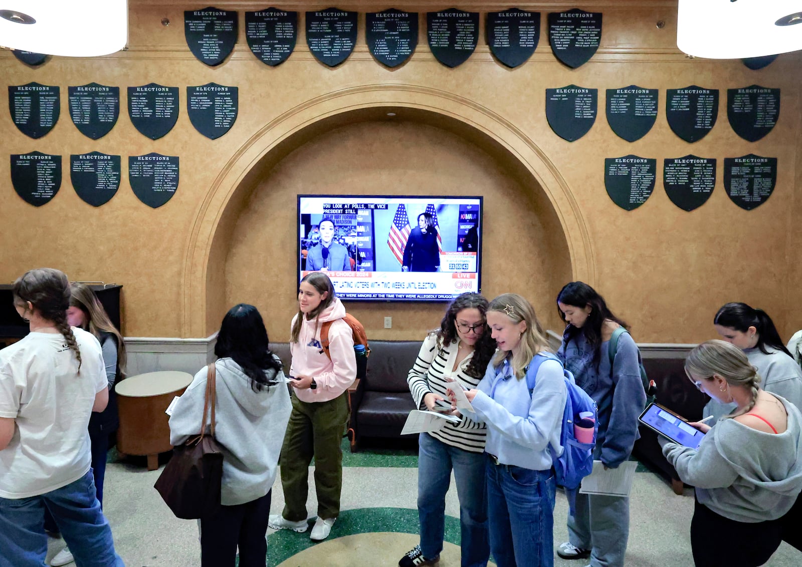 Students at The University of Wisconsin-Madison wait in line to cast their ballots in the 2024 election during the first day of Wisconsin's in-person absentee voting on the campus in Madison, Wisc., Tuesday, Oct. 22, 2024. (AP Photo/John Hart, Wisconsin State Journal)