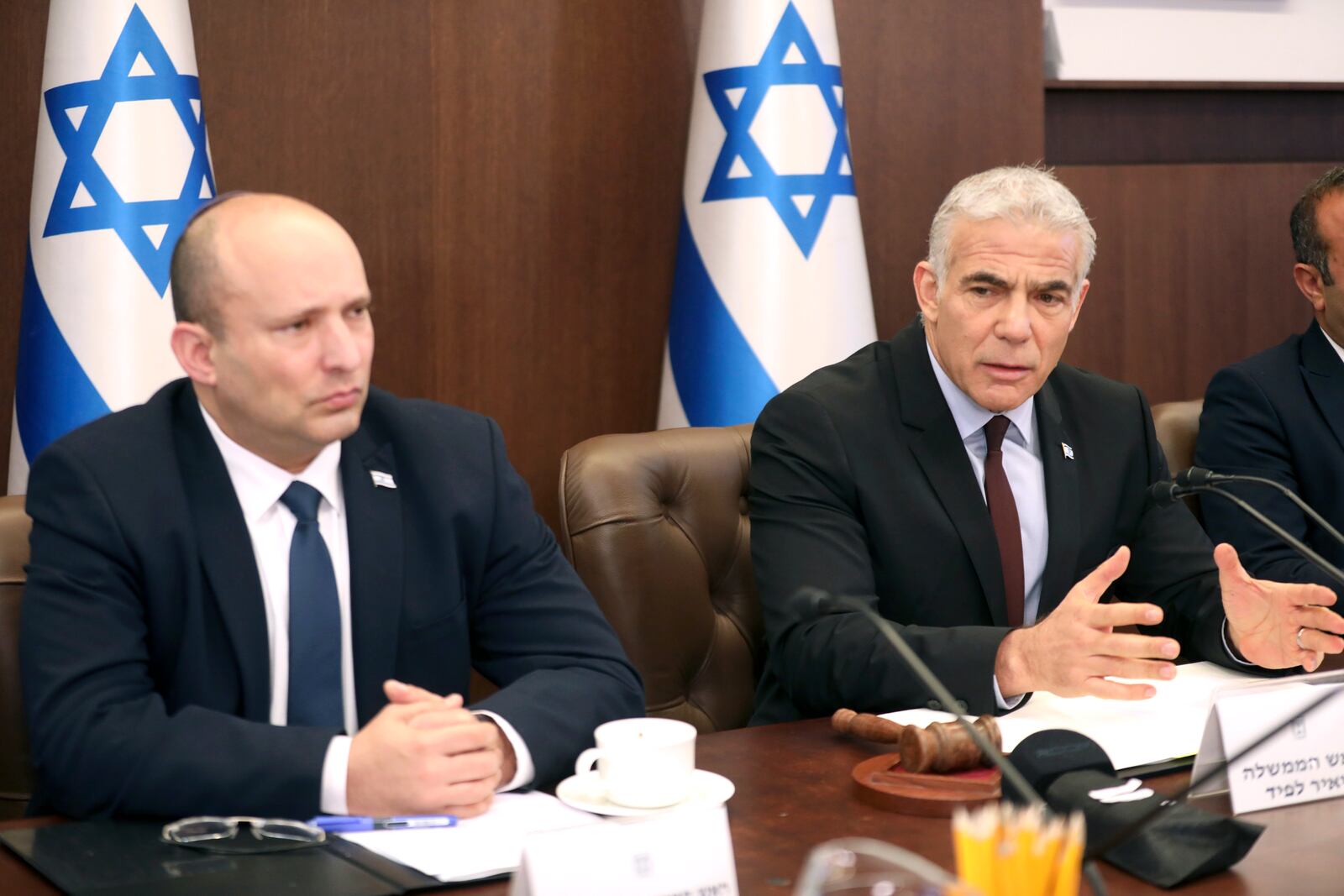 FILE - Israel's former Prime Minister Naftali Bennett, left, and caretaker Prime Minister Yair Lapid attend a cabinet meeting in Jerusalem on July 3, 2022. (Gil Cohen-Magen/Pool Photo via AP, File)