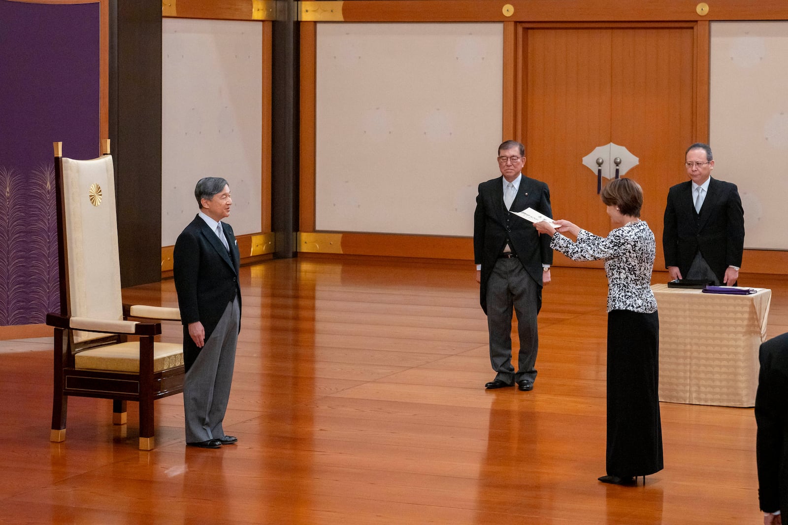 In this photo provided by Japan's Imperial Household Agency of Japan, Japan's Emperor Naruhito, left, stands before Junko Mihara, second right, newly appointed minister in charge of Policies Related to Children, as new Prime Minister Shigeru Ishiba, second left, looks on during the attestation ceremony at the Imperial Palace in Tokyo, Tuesday, Oct. 1, 2024. (Imperial Household Agency of Japan via AP)