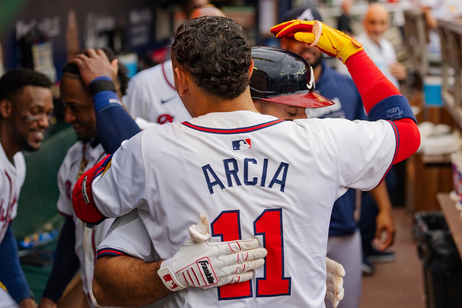 Atlanta Braves' Ramon Laureano, behind, celebrates with Atlanta Braves Orlando Arcia, front, in the dugout after hitting a solo home run to centerfield in the sixth inning of a baseball game against the New York Mets, Monday, Sept. 30, 2024, in Atlanta. (AP Photo/Jason Allen)