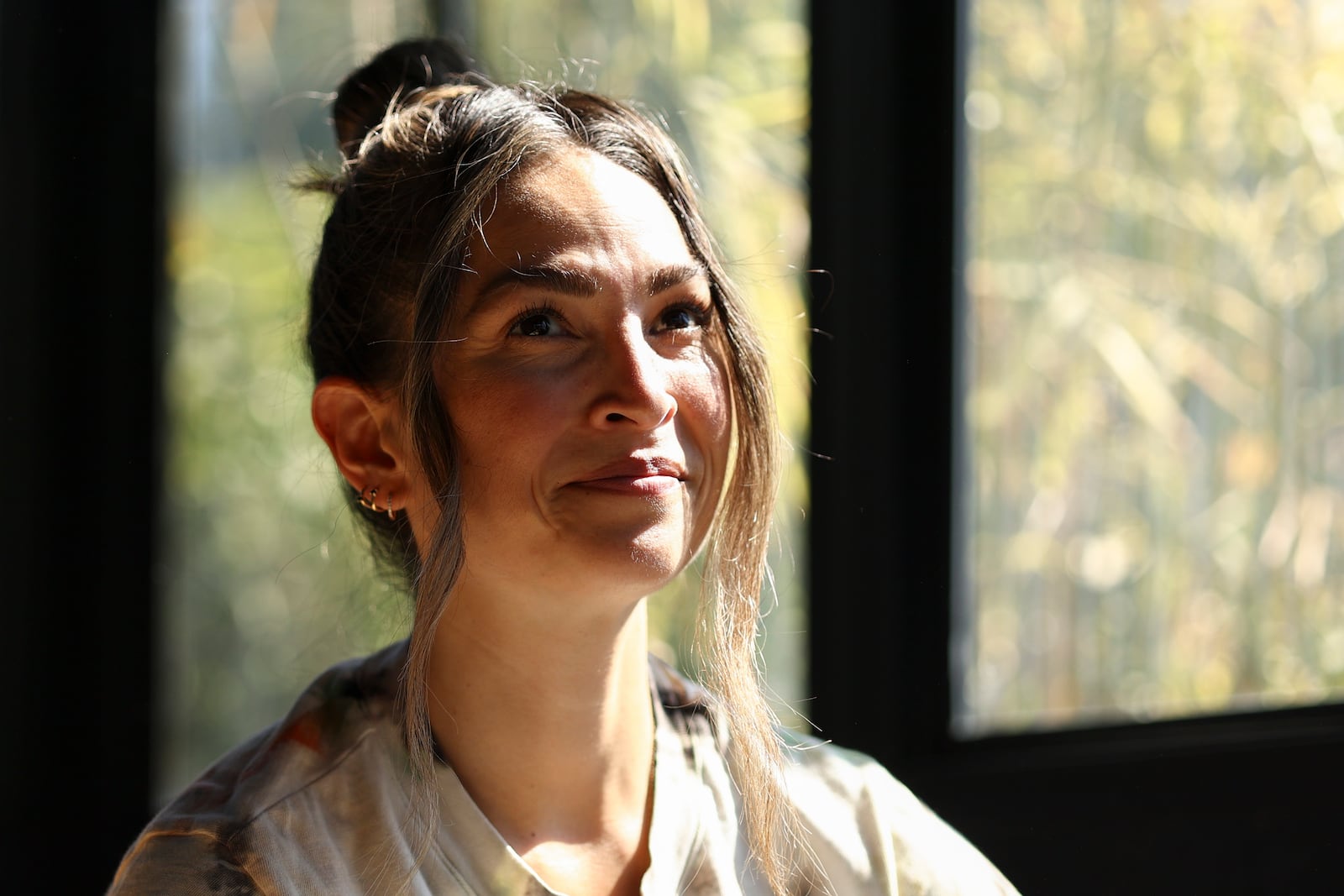 Headspace meditation teacher, Rosie Acosta, looks on in her sun room Monday, Sept. 30, 2024, in Woodland Hills, Calif. (AP Photo/Jessie Alcheh)