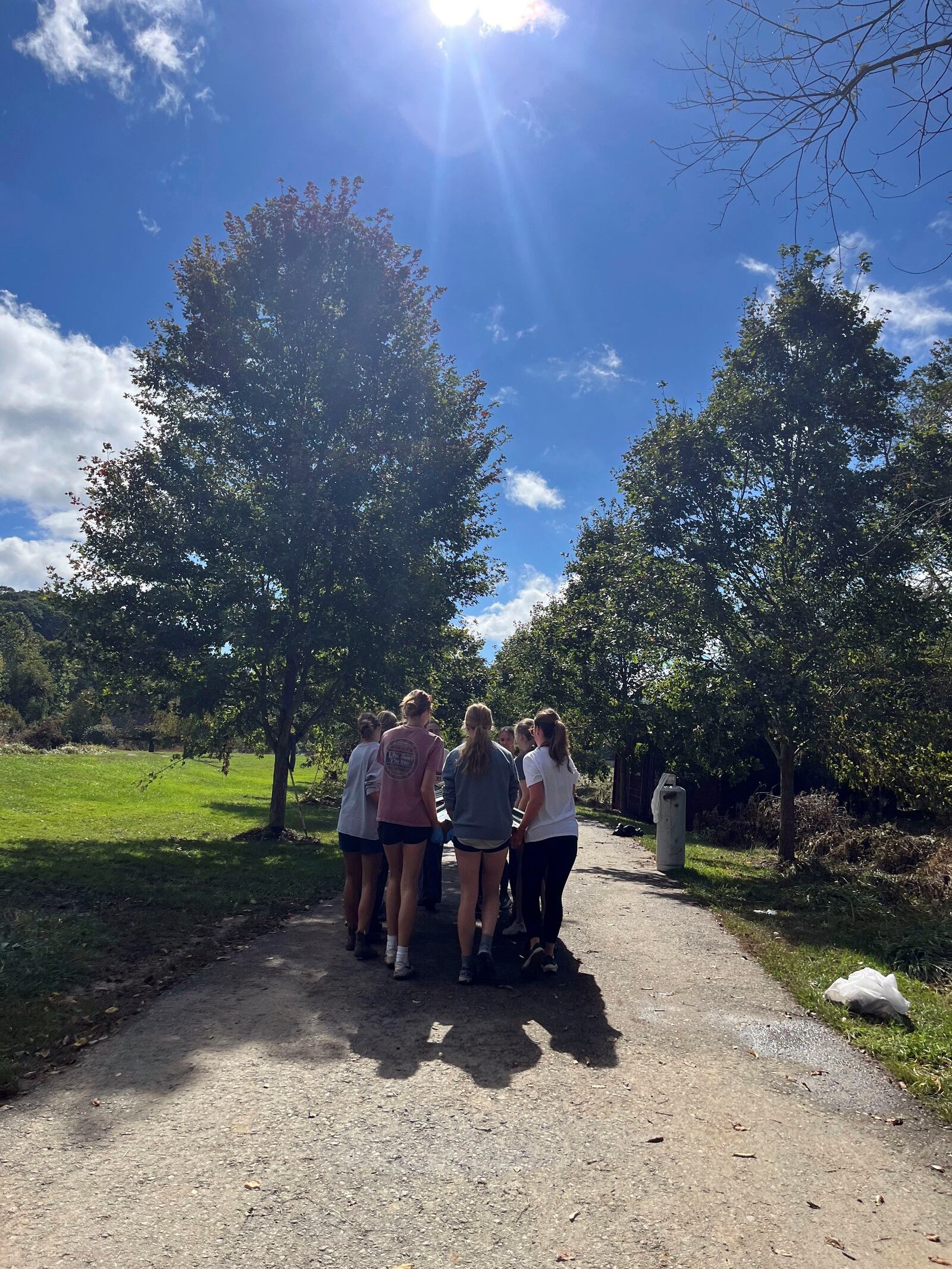 In this photo provided by Mary Walker, members of the girls cross country team at Watauga High School perform cleanup duties Wednesday, Oct. 2, 2024, along the Greenway Trail in Boone, N.C.. The area was hit hard by Hurricane Helene. (Mary Walker via AP)