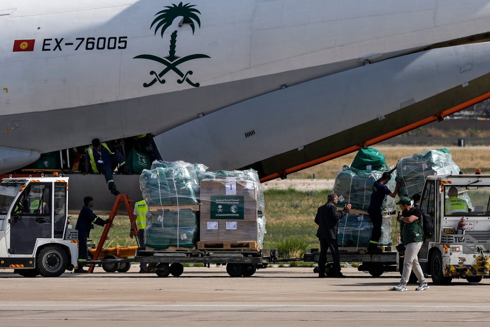 Workers unload Saudi medical aid boxes arriving at the Beirut International airport, Lebanon, Sunday, Oct. 13, 2024. (AP Photo/Bilal Hussein)