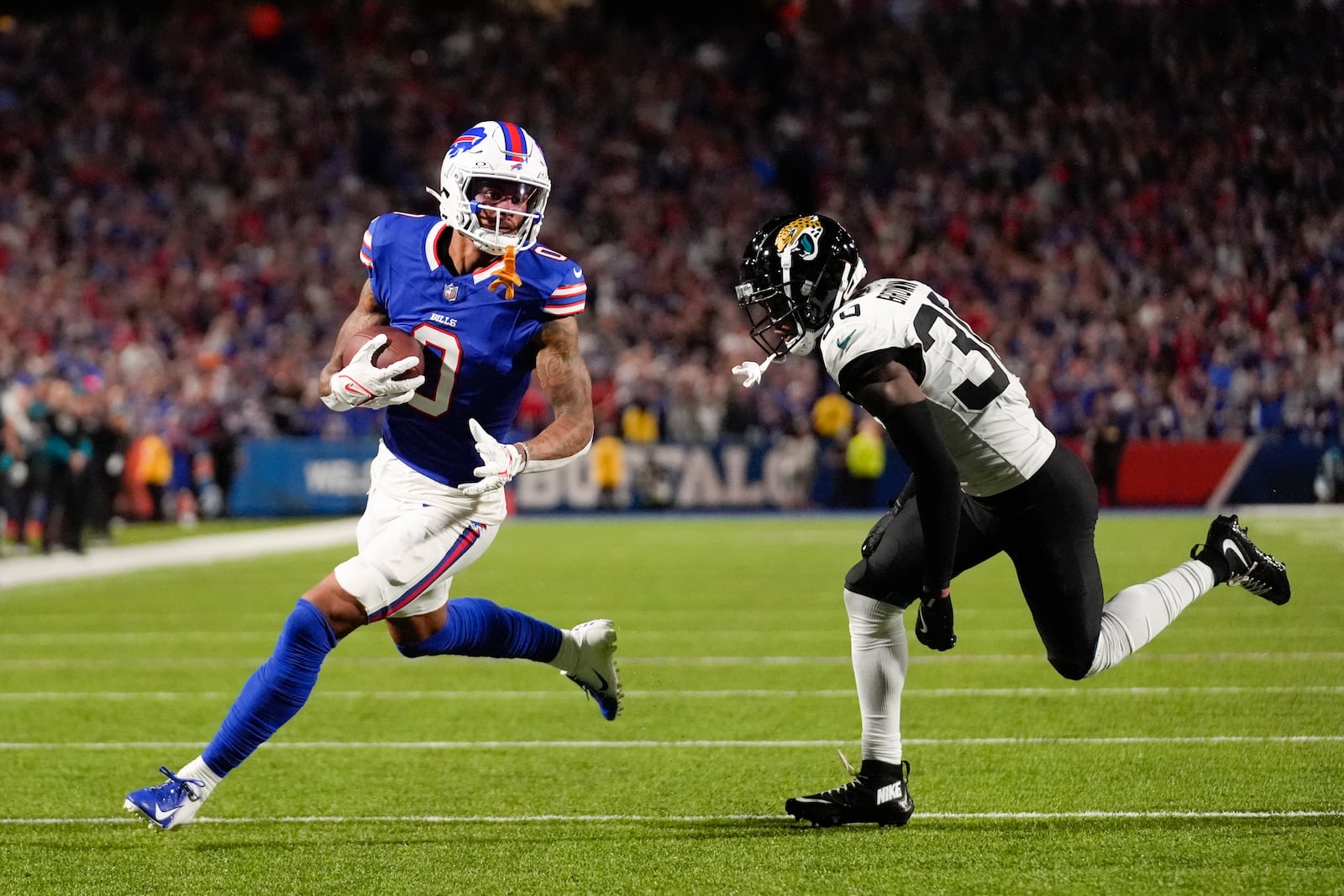 Buffalo Bills wide receiver Keon Coleman, left, scores a touchdown past Jacksonville Jaguars cornerback Montaric Brown during the first half of an NFL football game Monday, Sept. 23, 2024, in Orchard Park, NY. (AP Photo/Steven Senne)