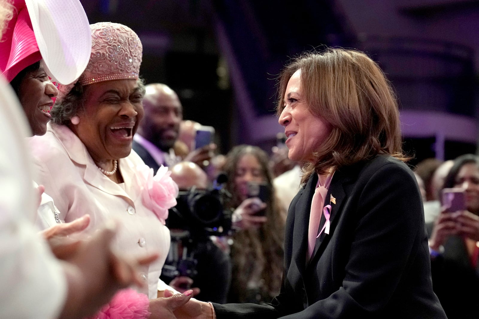 Democratic presidential nominee Vice President Kamala Harris, right, greets attendees as she arrives at a church service at New Birth Baptist Church in Stonecrest, Ga., Sunday, Oct. 20, 2024. (AP Photo/Jacquelyn Martin)