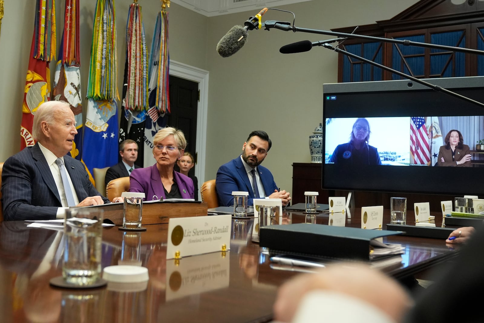 President Joe Biden, from left, joined by Energy Secretary Jennifer Granholm, White House climate adviser Ali Zaidi, and on screen from left, FEMA Administrator Deanne Criswell and Vice President Kamala Harris, speaks about the federal government's response to Hurricanes Milton and Helene, in the Roosevelt Room of the White House, Friday, Oct. 11, 2024, in Washington. (AP Photo/Manuel Balce Ceneta)