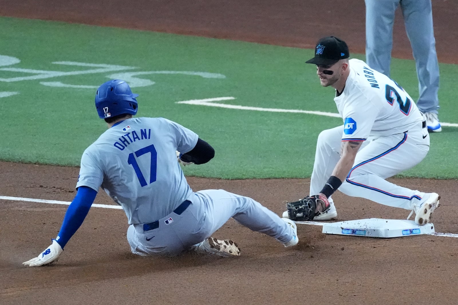 Los Angeles Dodgers' Shohei Ohtani (17) of Japan, steals third base as Miami Marlins third baseman Connor Norby attempts the tag during the first inning of a baseball game, Thursday, Sept. 19, 2024, in Miami. (AP Photo/Wilfredo Lee)