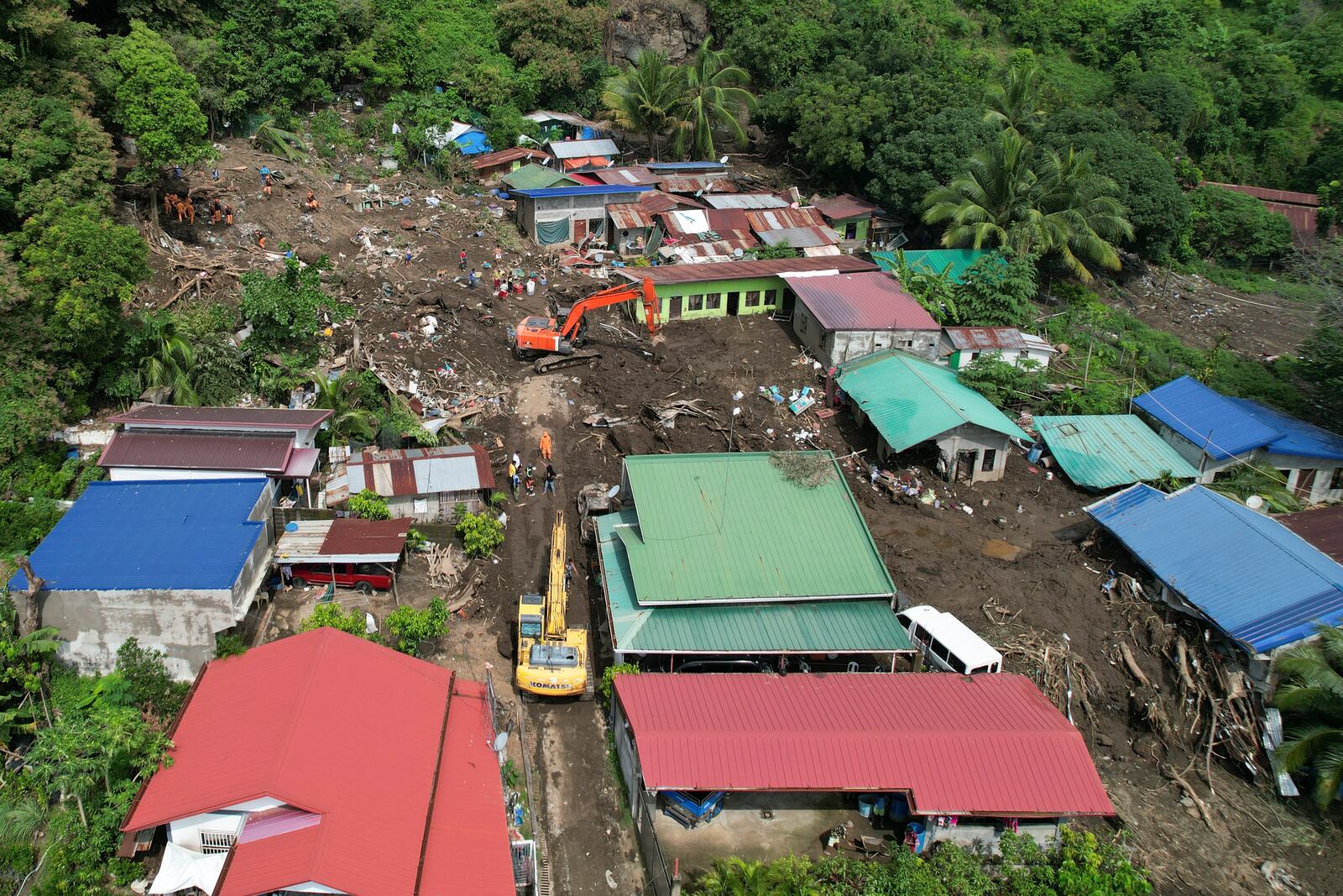 Rescuers search for bodies after a landslide triggered by Tropical Storm Trami struck homes in Talisay, Batangas province, Philippines on Saturday, Oct. 26, 2024. (AP Photo/Aaron Favila)