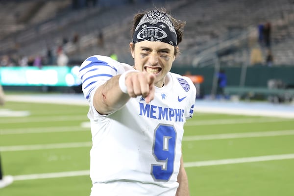 Memphis quarterback Seth Henigan (9) celebrates his team's 34-24 victory over Tulane in the second half of an NCAA college football game in New Orleans, Thursday, Nov. 28, 2024. (AP Photo/Peter Forest)