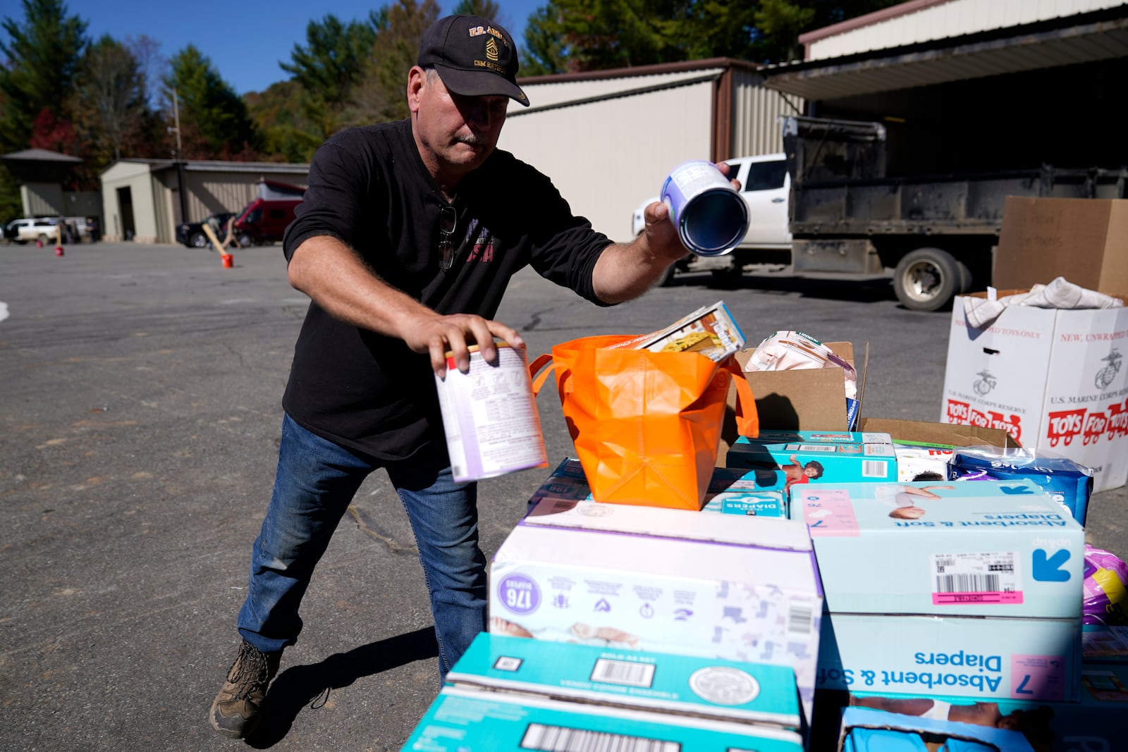 Alex Nelson, a retired non-commissioned military officer, volunteers at the Elk River Airport supply distribution center, Tuesday, Oct. 8, 2024, in Avery County, N.C. (AP Photo/Erik Verduzco)