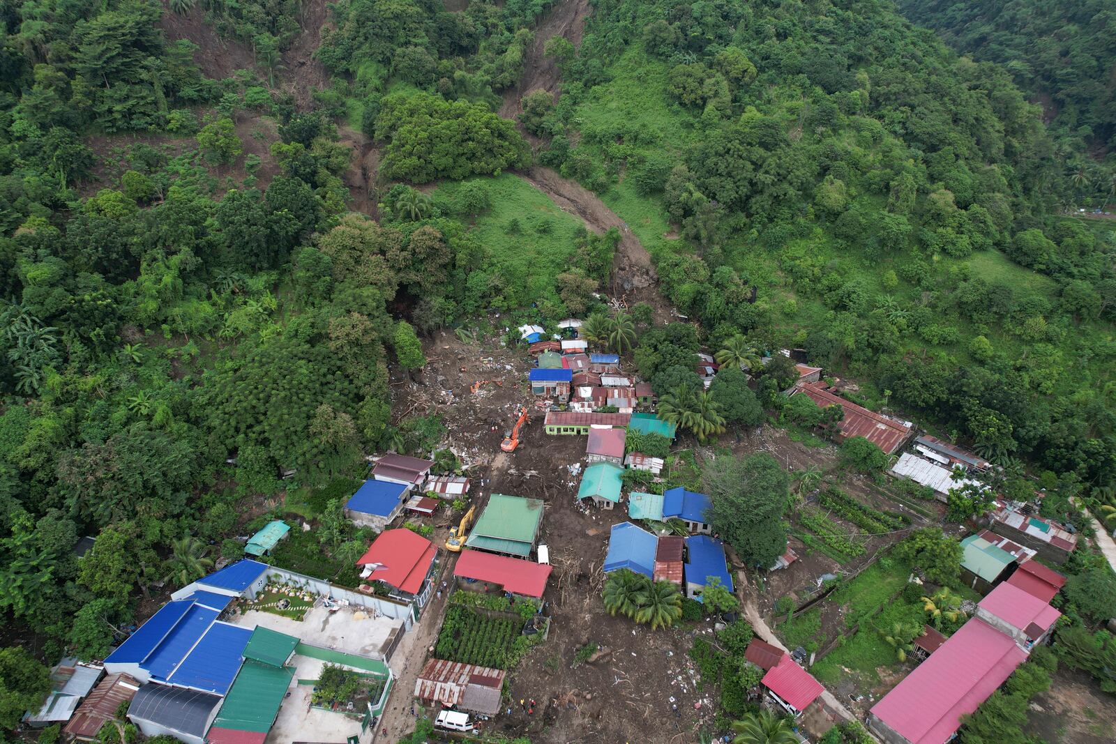 Rescuers work at the site after a recent landslide triggered by Tropical Storm Trami struck Talisay, Batangas province, Philippines leaving thousands homeless and several villagers dead on Saturday, Oct. 26, 2024. (AP Photo/Aaron Favila)