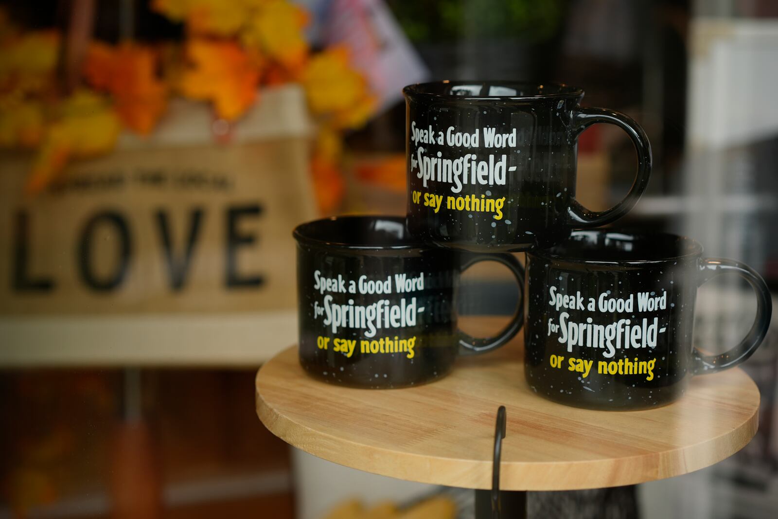 Mugs that read "Speak a Good Word for Springfield or say nothing" are displayed in the Champion City Guide & Supply shop window on Tuesday, Sept. 17, 2024, in Springfield, Ohio. (AP Photo/Carolyn Kaster)